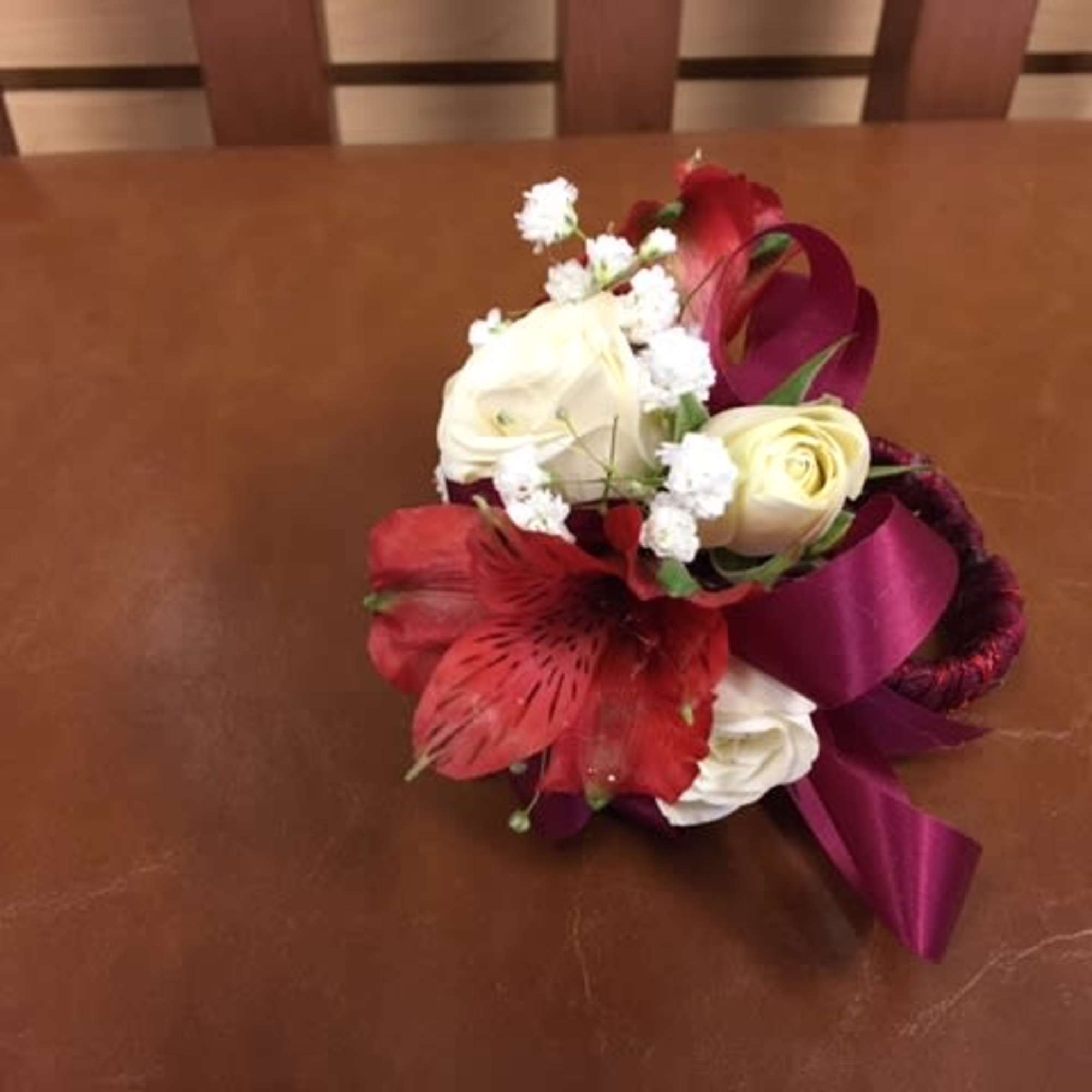 White spray roses, baby breath, dark red alstroemeria, wrapped burgundy band White spray roses, baby breath, dark red alstroemeria, wrapped burgundy band