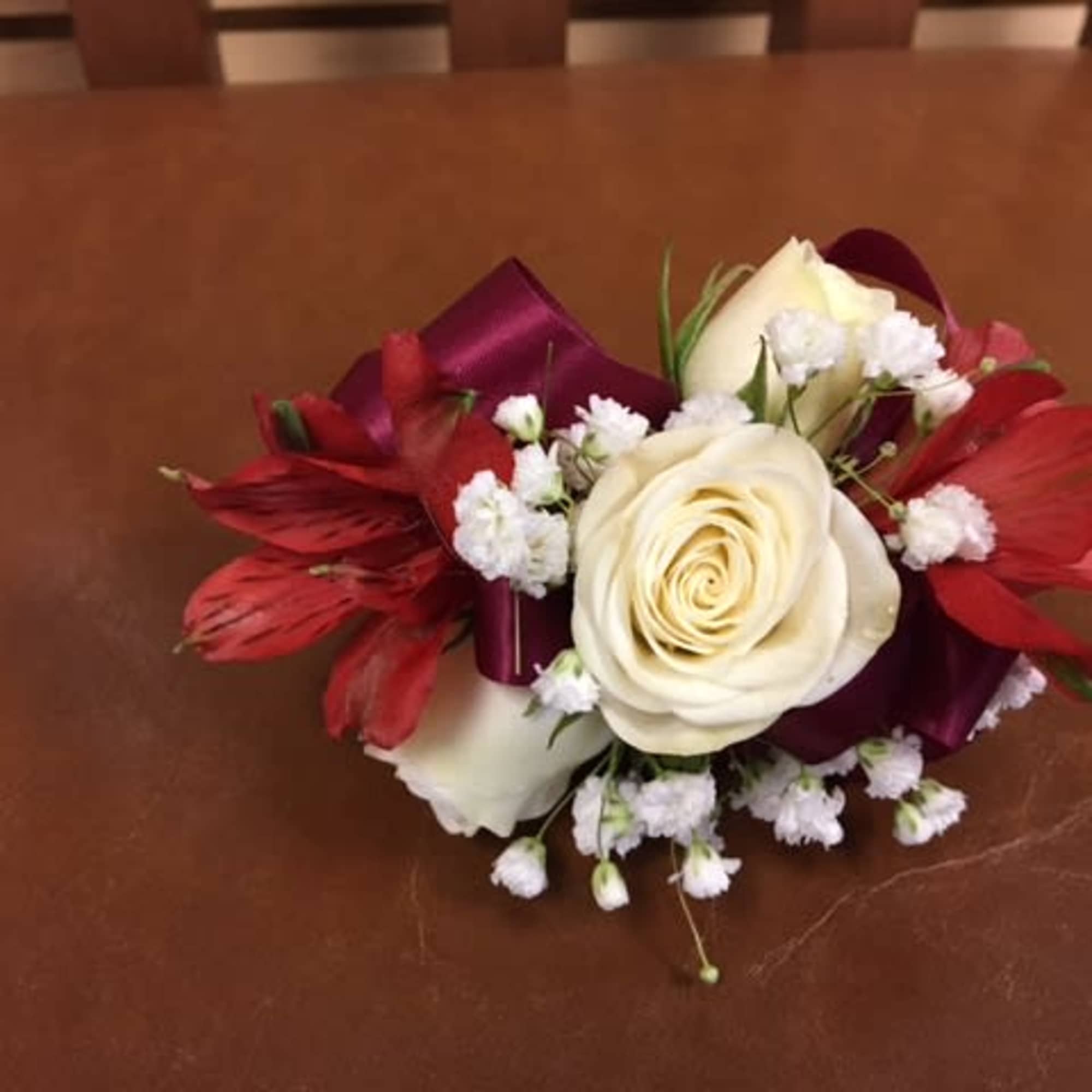 White spray roses, baby breath, dark red alstroemeria, wrapped burgundy band White spray roses, baby breath, dark red alstroemeria, wrapped burgundy band
