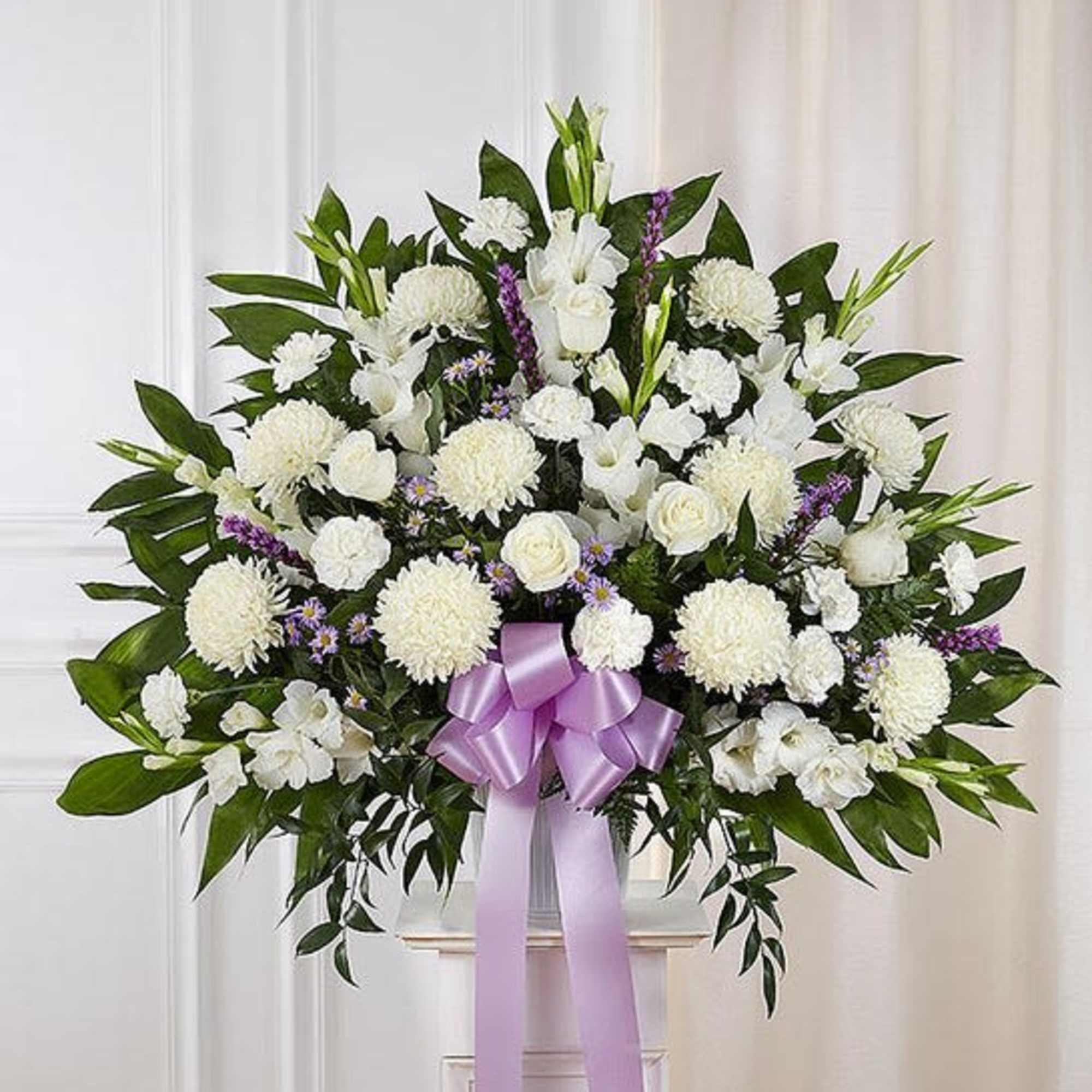 Standing basket arrangement with white roses, football mums, stock and carnations; lavender
