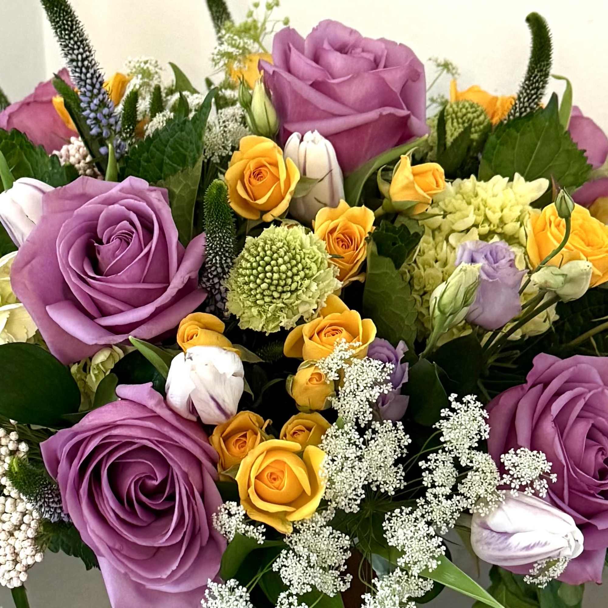 Variety of colorful flowers in cylinder vase Variety of colorful flowers in cylinder vase