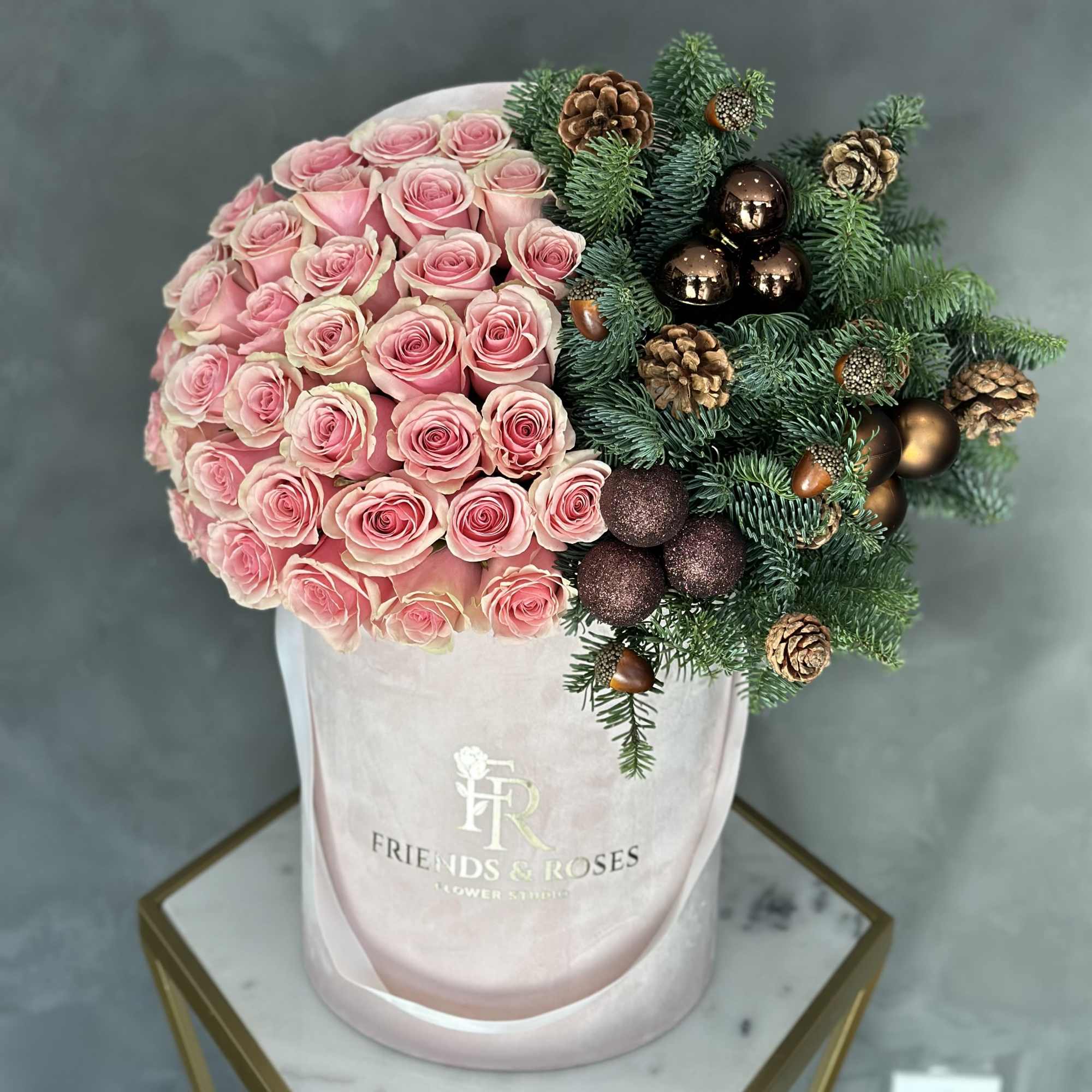 Celebrate the season with this stunning bouquet of soft pink roses, accented