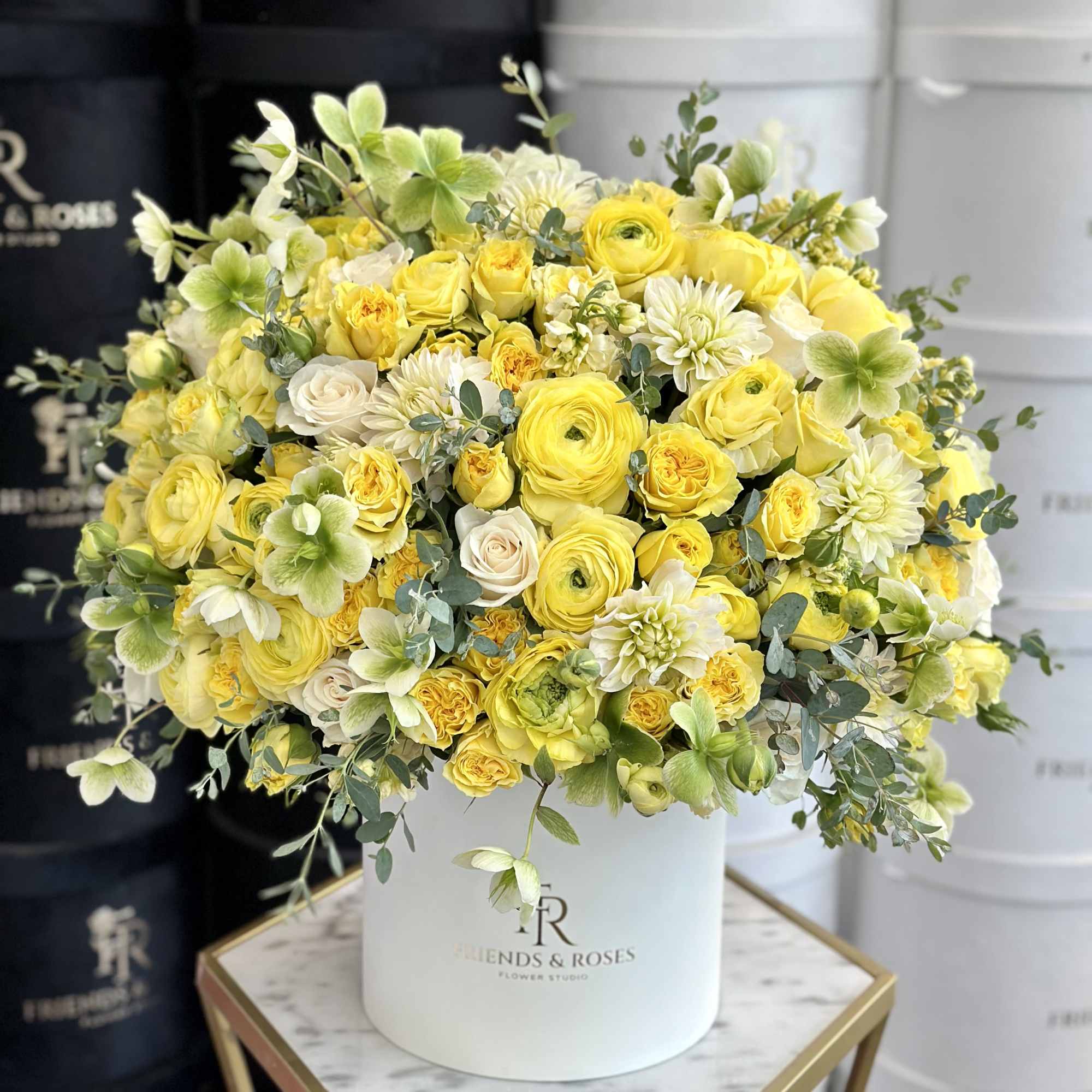 The box contains a carefully arranged selection of vibrant yellow premium-class flowers
