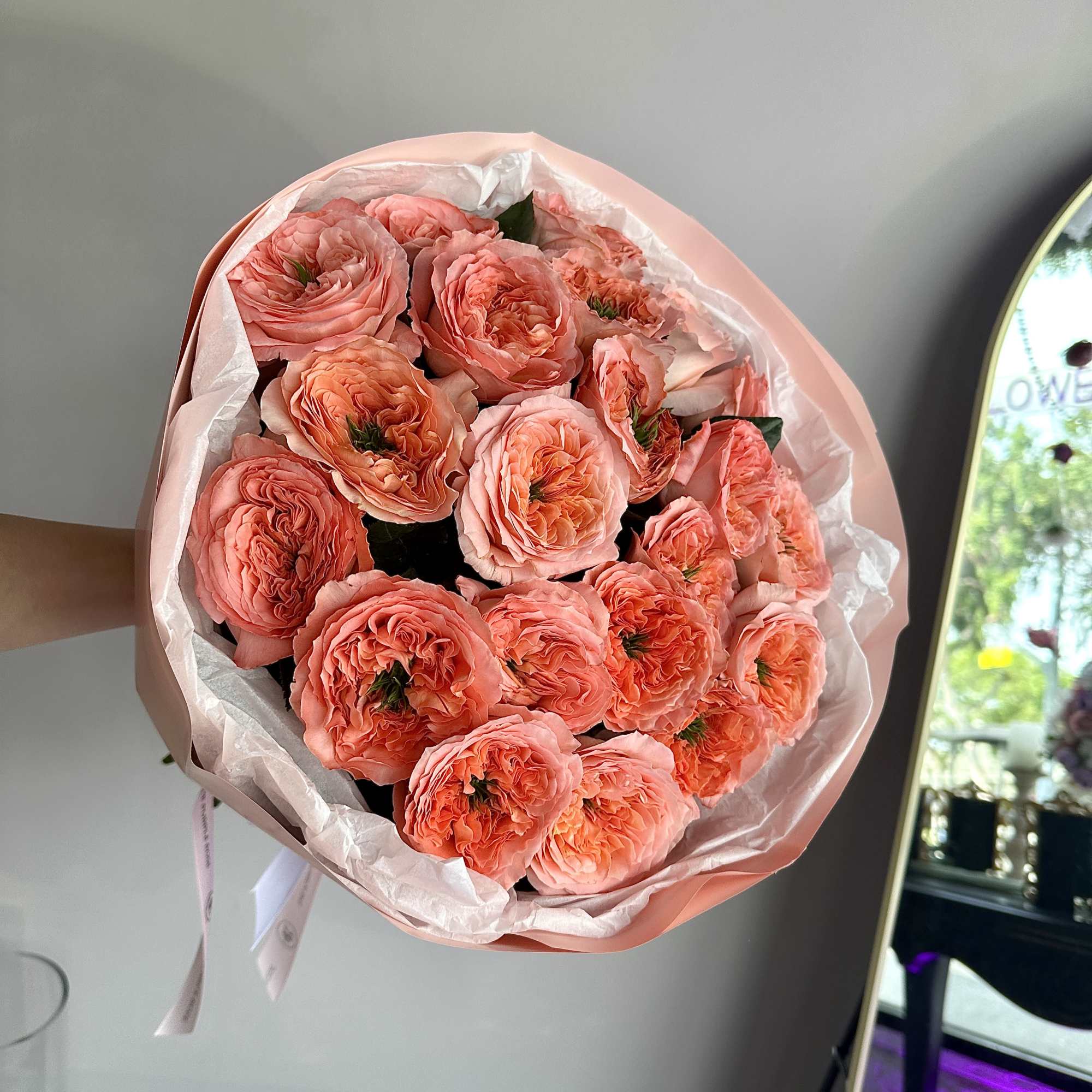 Full of charm and texture, this bouquet of coral-toned garden roses is