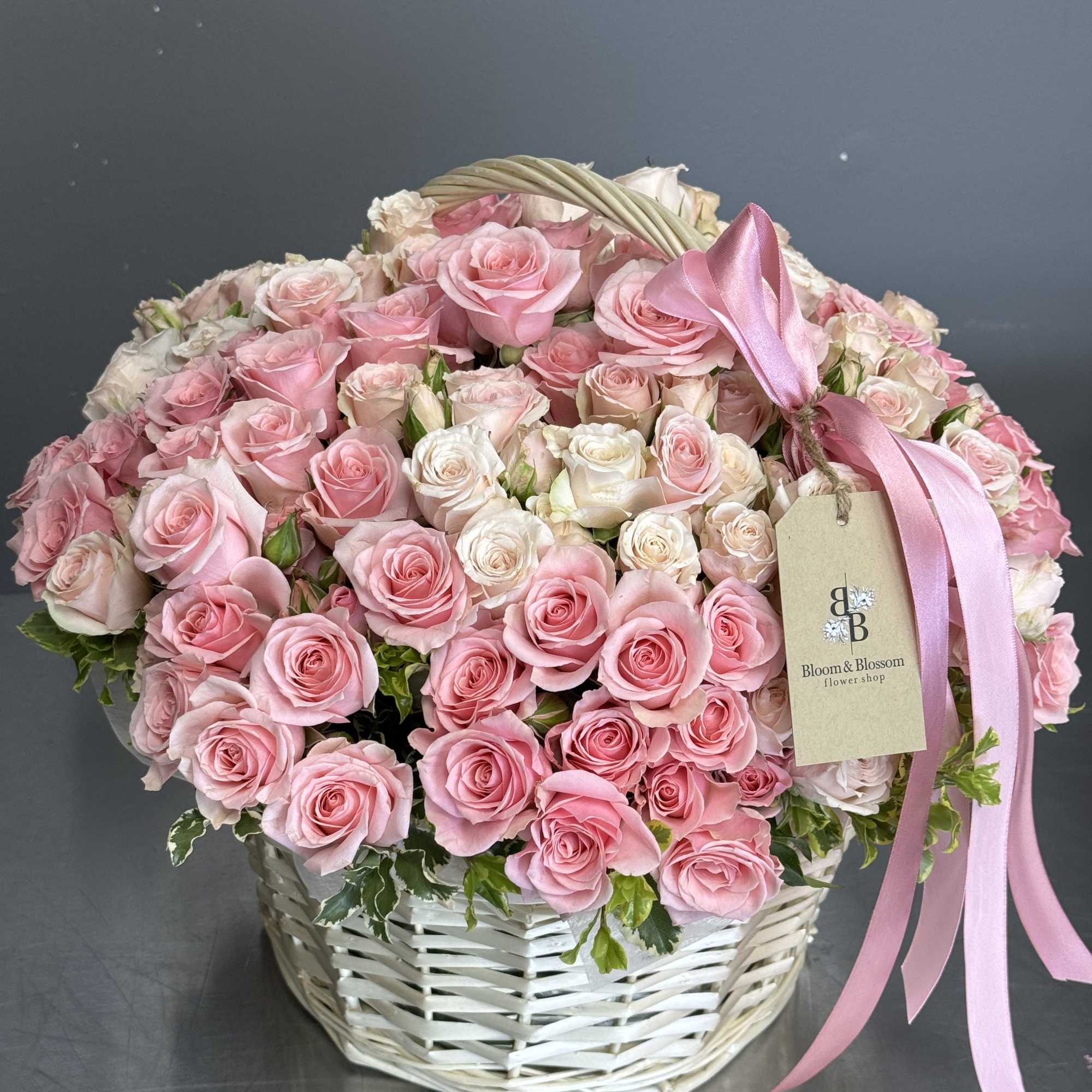 Love language is a basket arrangement full of beautiful mixed spray roses.