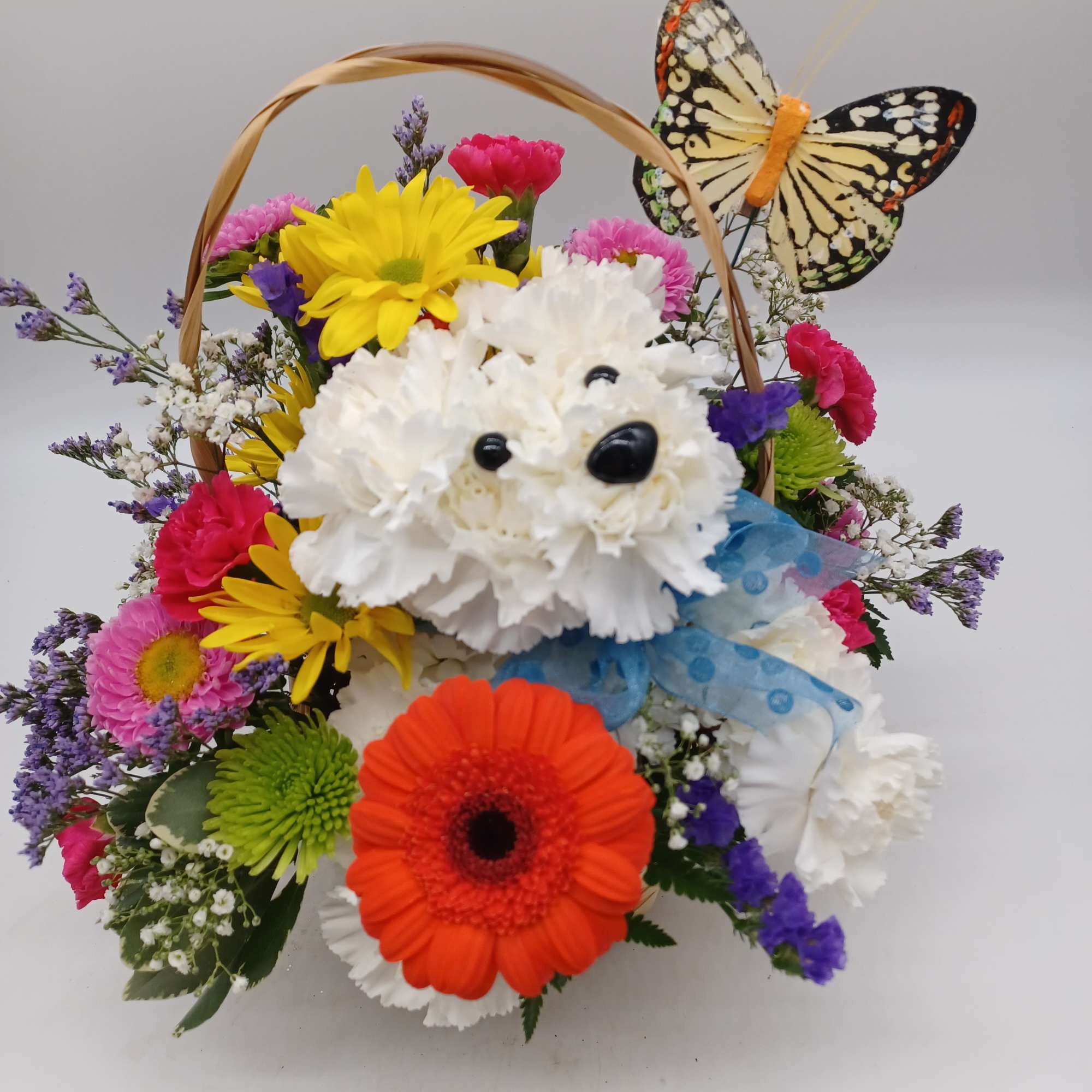 Designed out of white carnations, this puppy is sure to put 