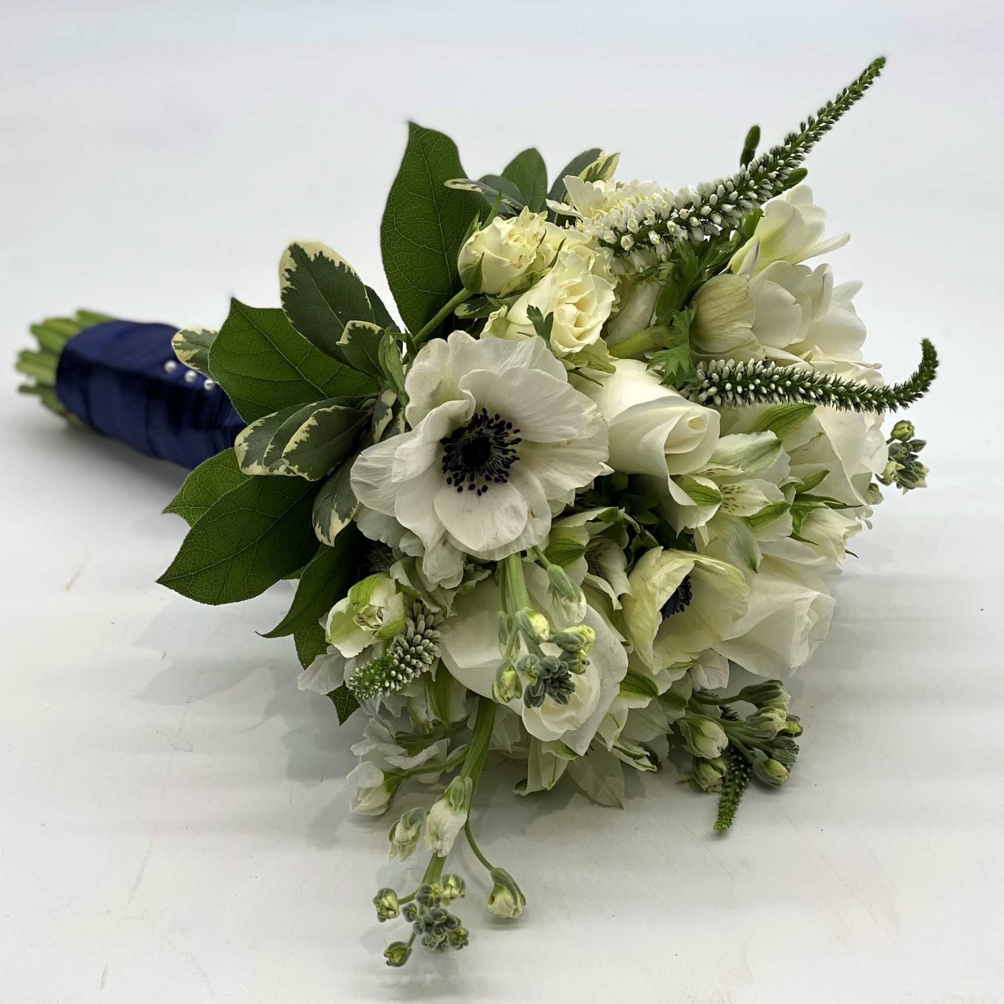 Lush whites with the beautiful pop of a white anemone with dark