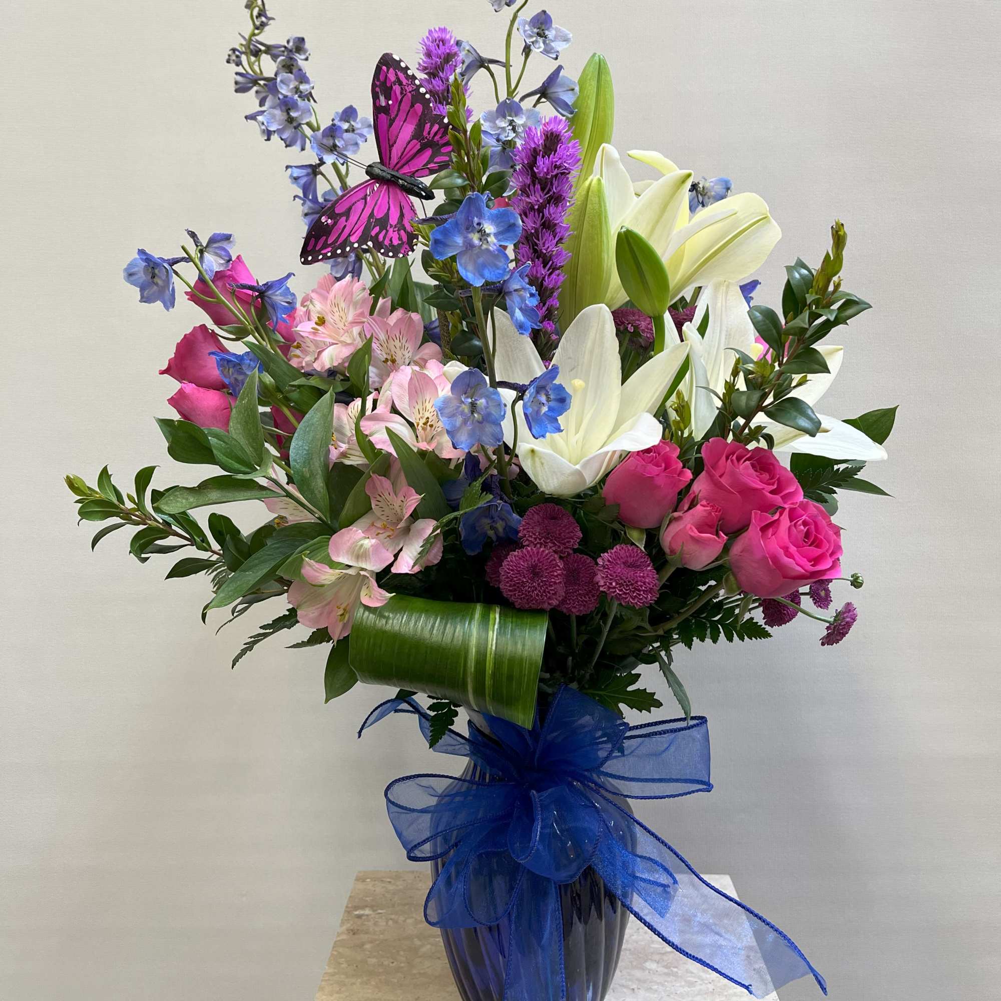 Blue vase in shades of pink, purple, white, and blue. 
Appropriate for Blue vase in shades of pink, purple, white, and blue. 
Appropriate for
