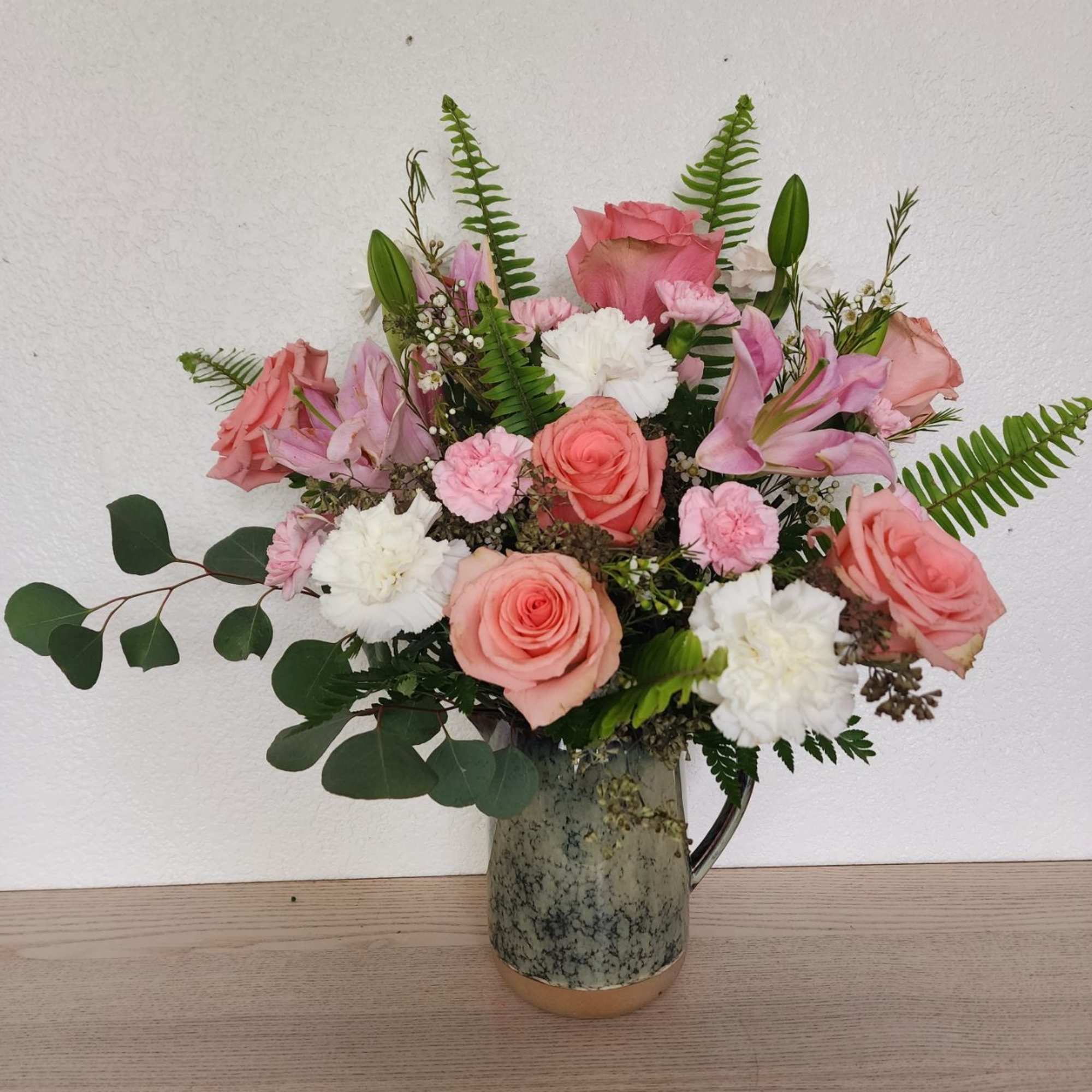 Grey Garden Glory is a stunning arrangement where bold, vibrant blooms burst