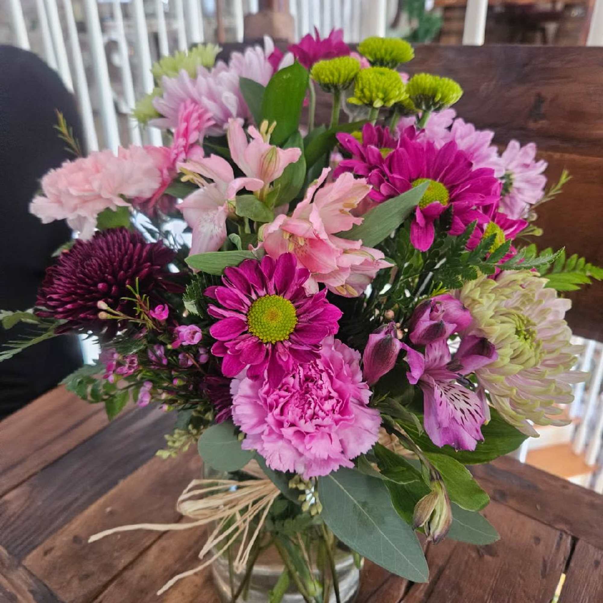 Purple daisys, lavender chrysanthemums, purple cremon, pink and purple alstomeria, green button