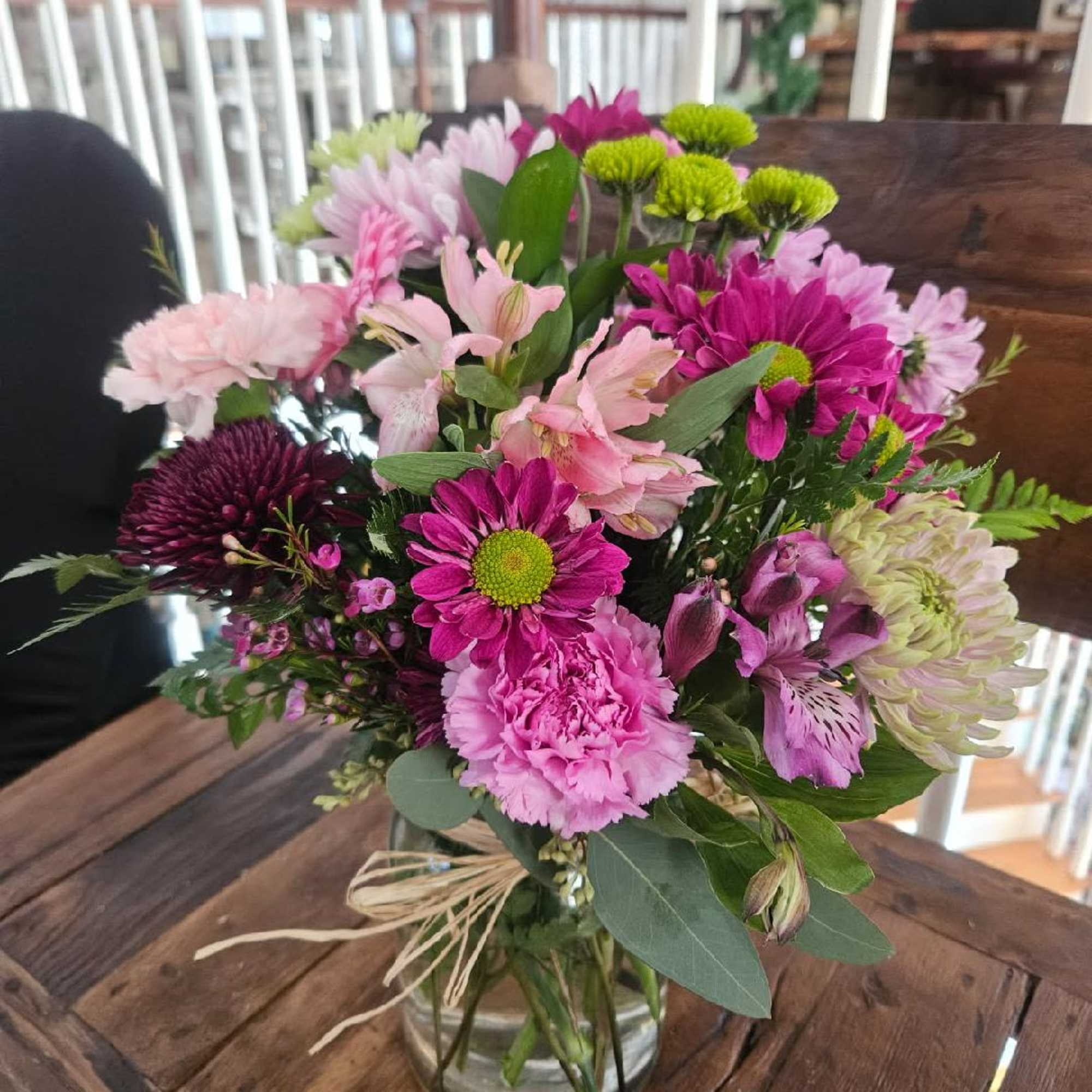 Purple daisys, lavender chrysanthemums, purple cremon, pink and purple alstomeria, green button