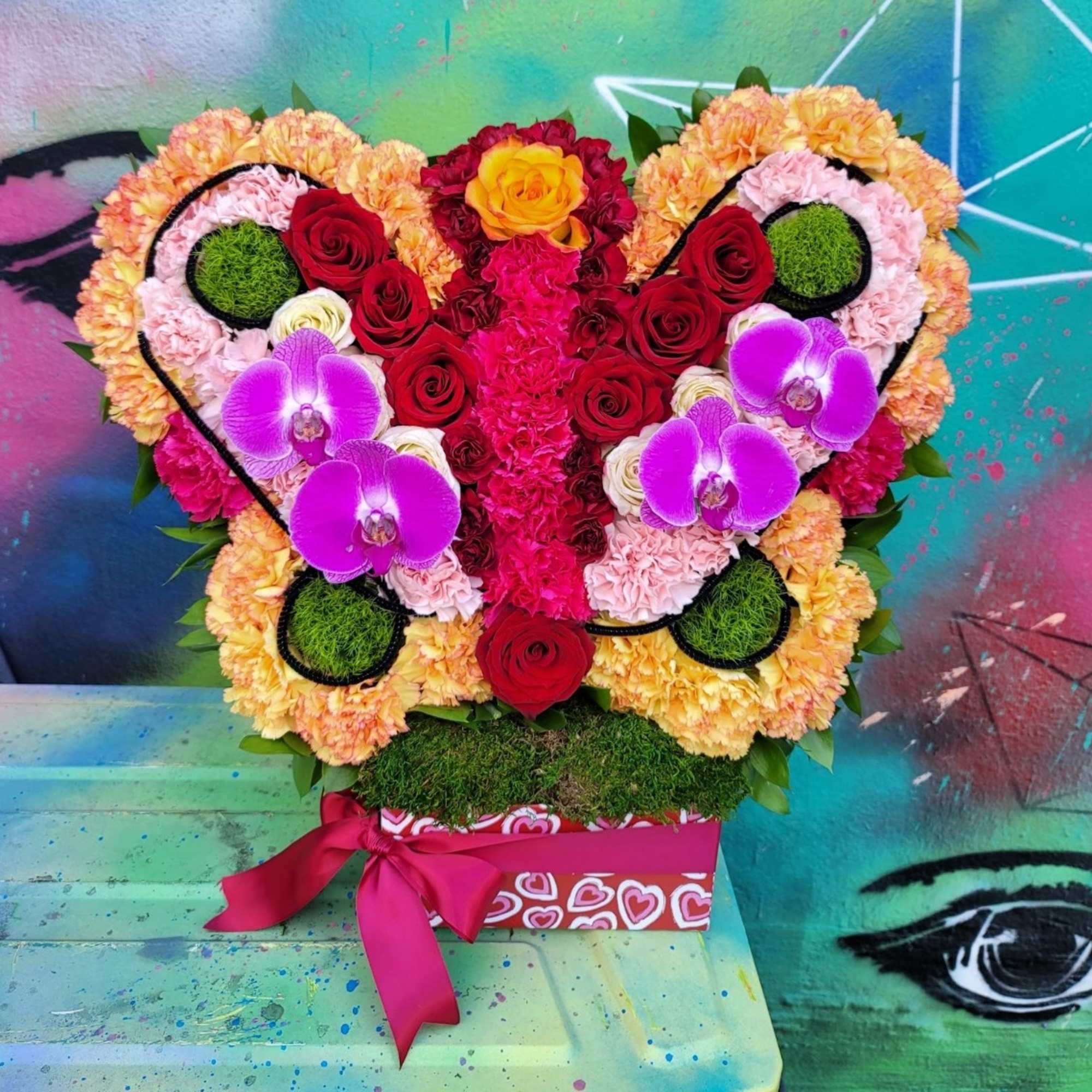 A Natural butterfly arrangement made of different flowers such as roses, bottoms A Natural butterfly arrangement made of different flowers such as roses, bottoms