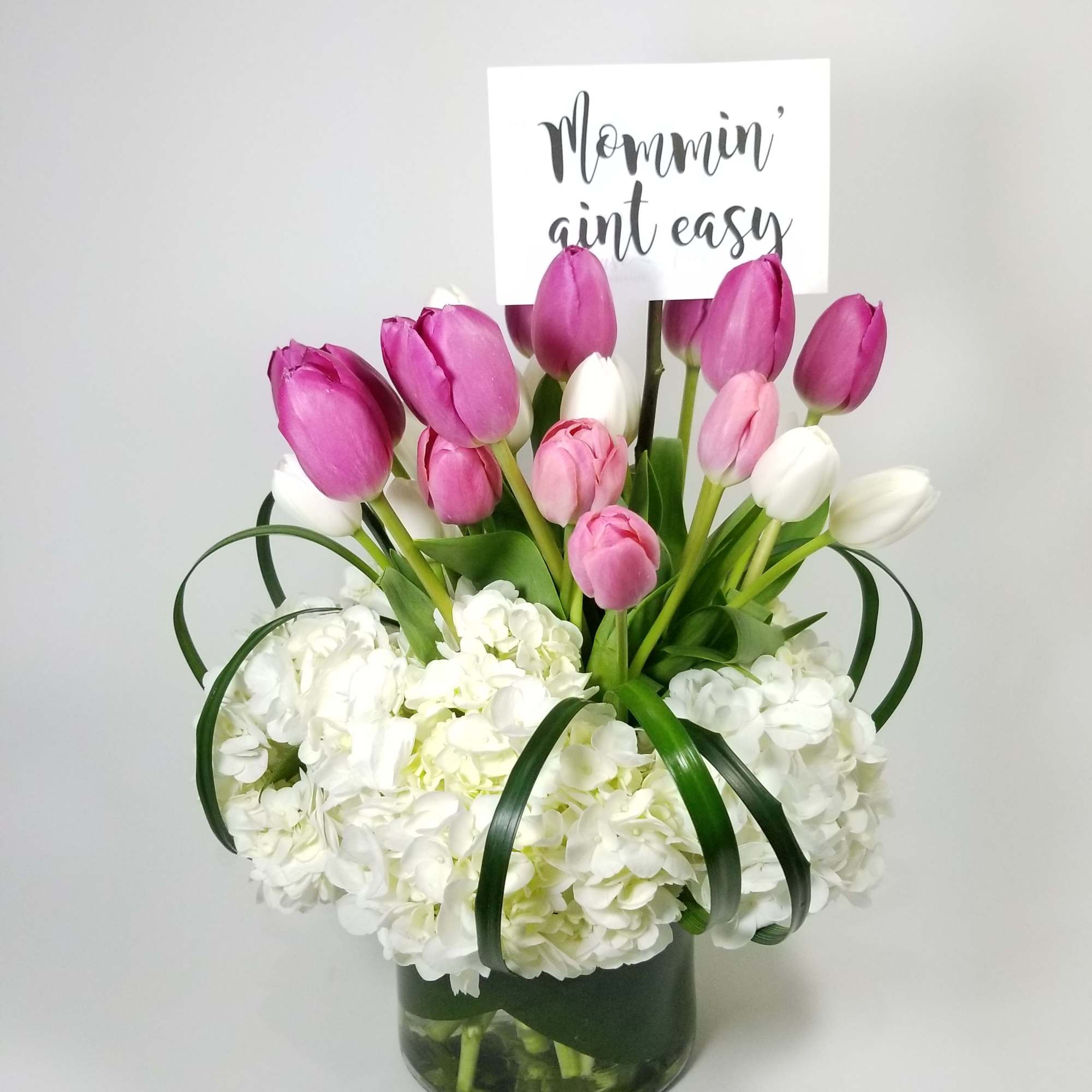 Arrangement of White Hydrangeas, Color Tulips and Greens.  

Approximately  10&#039;