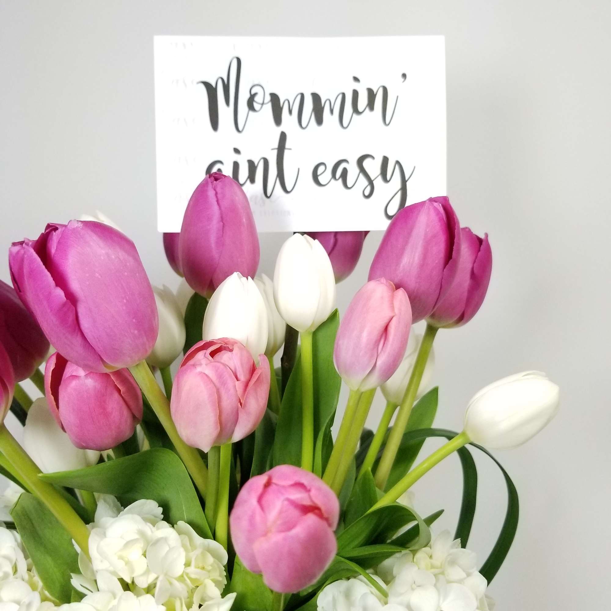 Arrangement of White Hydrangeas, Color Tulips and Greens.  

Approximately  10&#039;