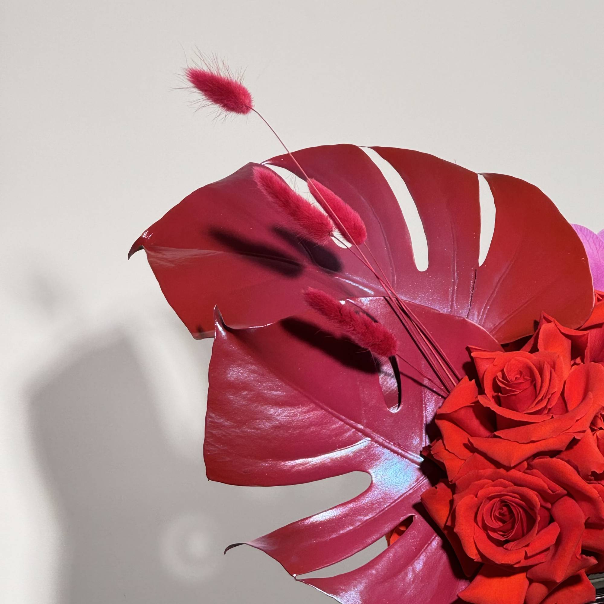 - Elegant purple orchids paired with bold, red painted leaves
- Unique silver