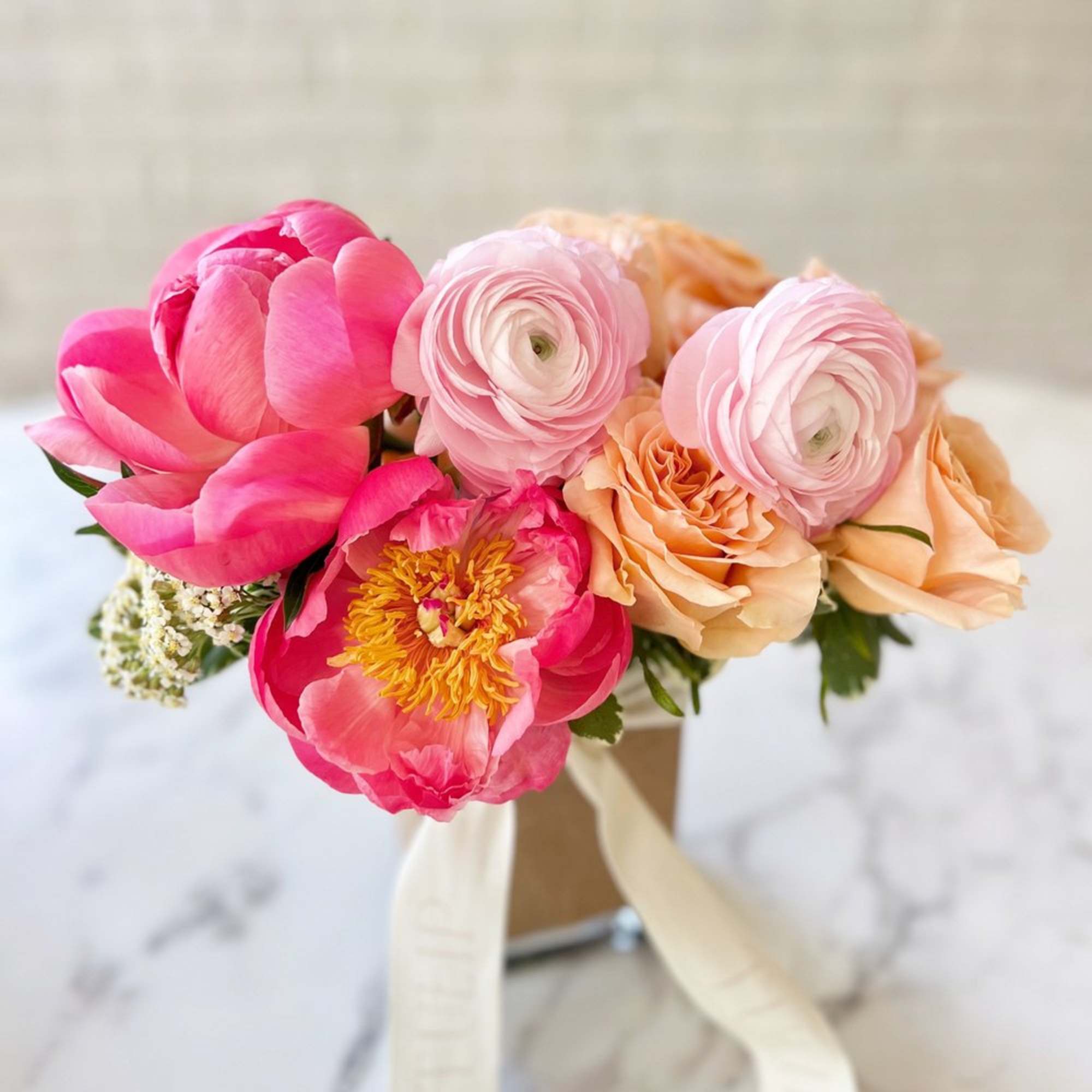 A seasonal mix of the freshest blooms designed in a vibrant, juicy