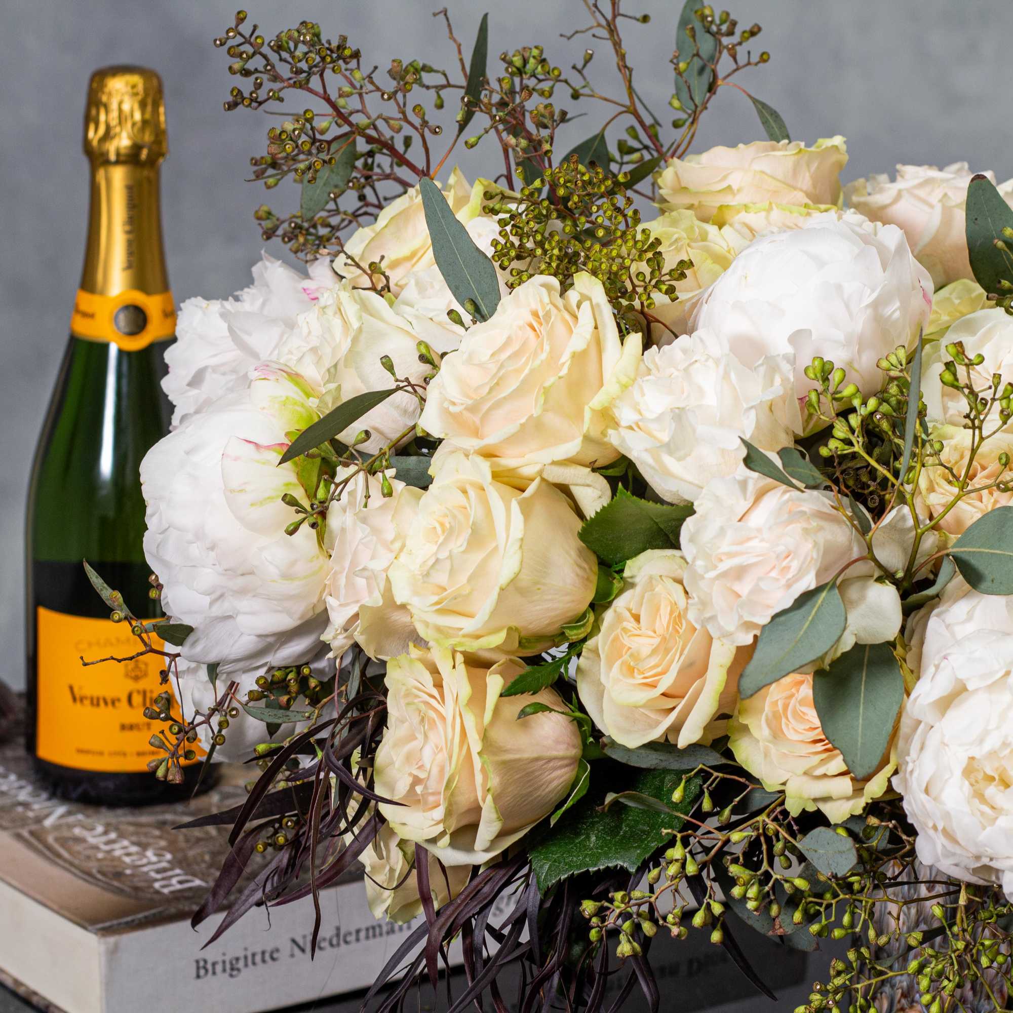 In a sleek, dark ceramic vase, a harmonious blend of white and In a sleek, dark ceramic vase, a harmonious blend of white and