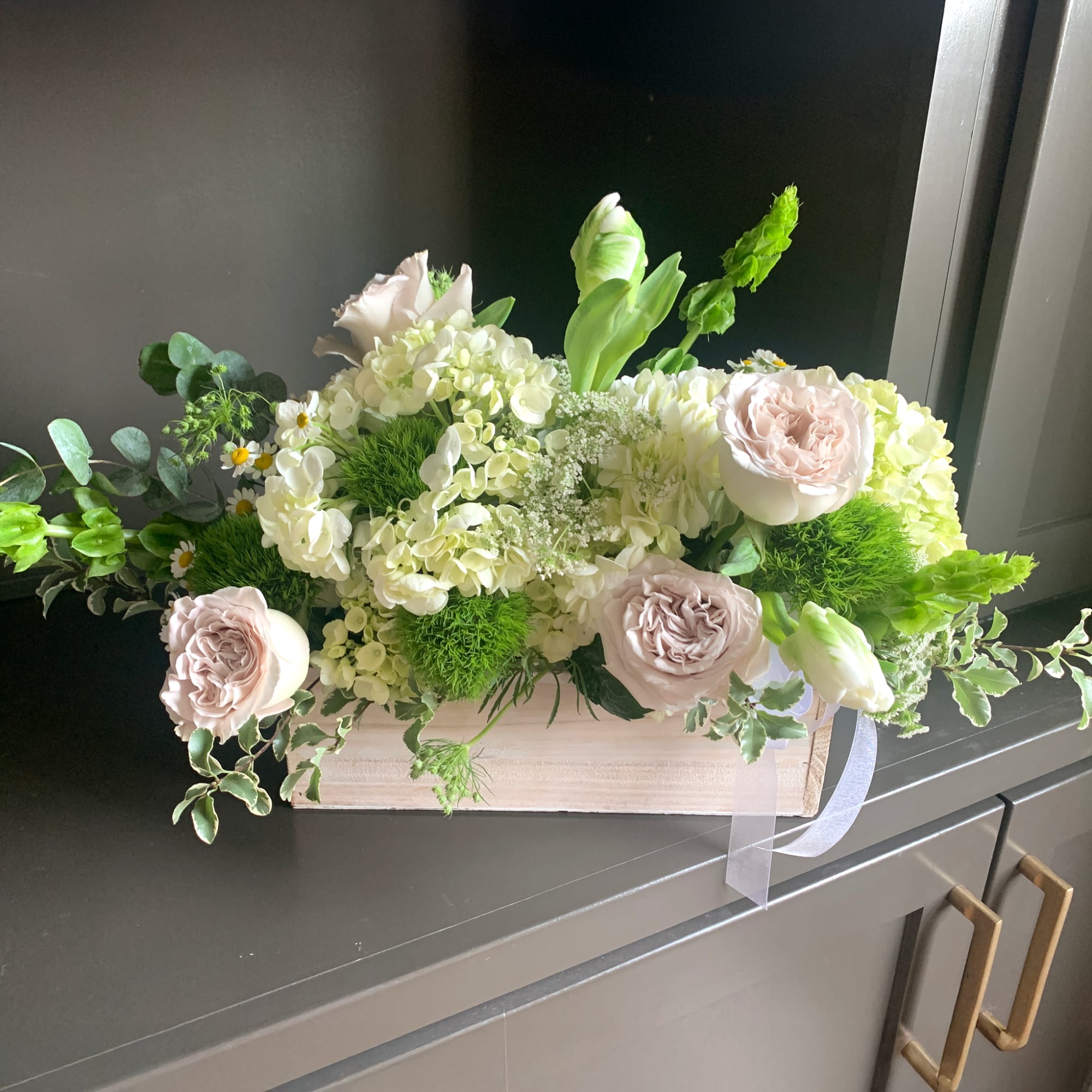 This crisp white and green arrangement is the perfect gift for a