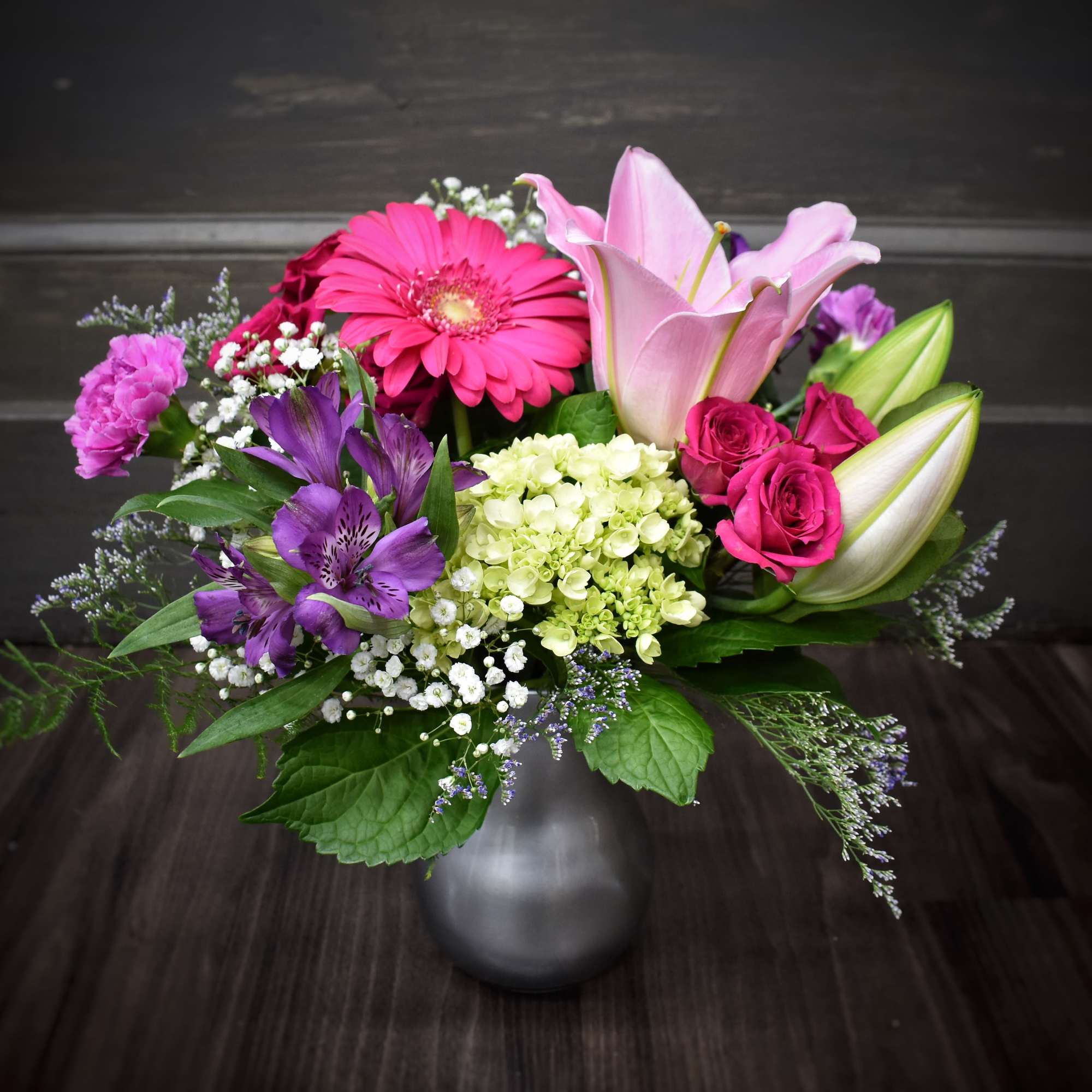 This brightly colored bouquet full of fresh flowers will brighten anybody's day This brightly colored bouquet full of fresh flowers will brighten anybody's day