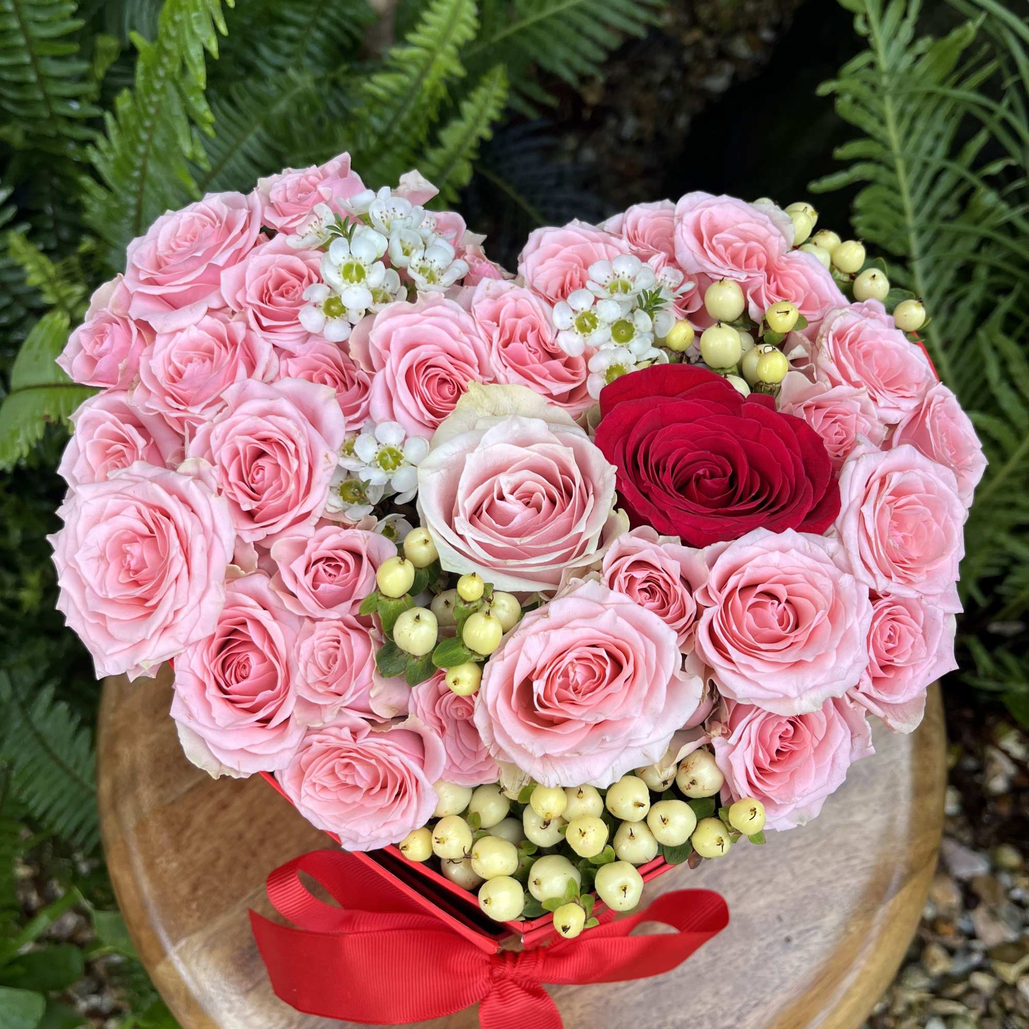 This Valentine’s box holds a secret. Beneath the freshly cut rose blossoms This Valentine’s box holds a secret. Beneath the freshly cut rose blossoms
