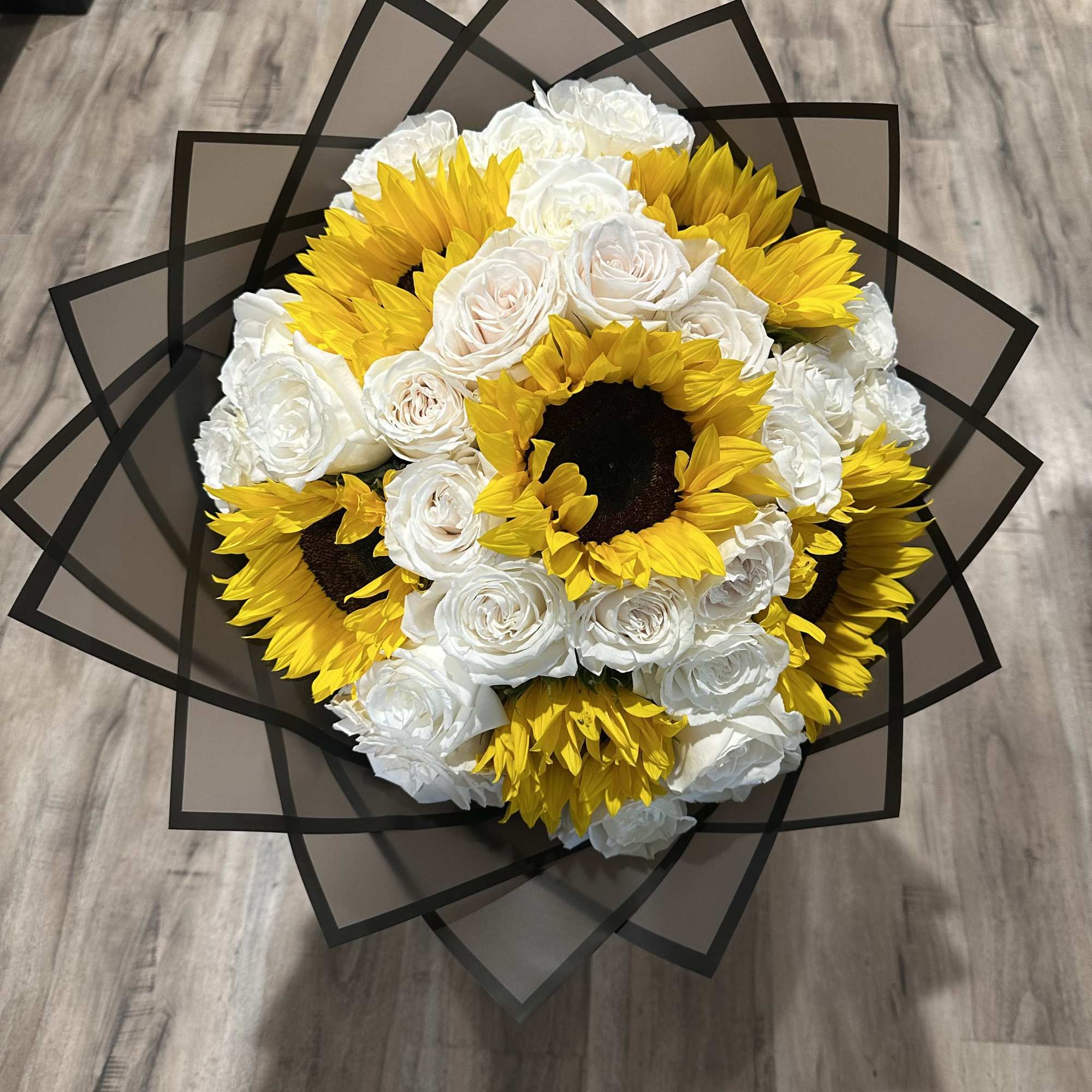 Beautiful sunflowers with white long stem roses wrapped in a luxurious Korean