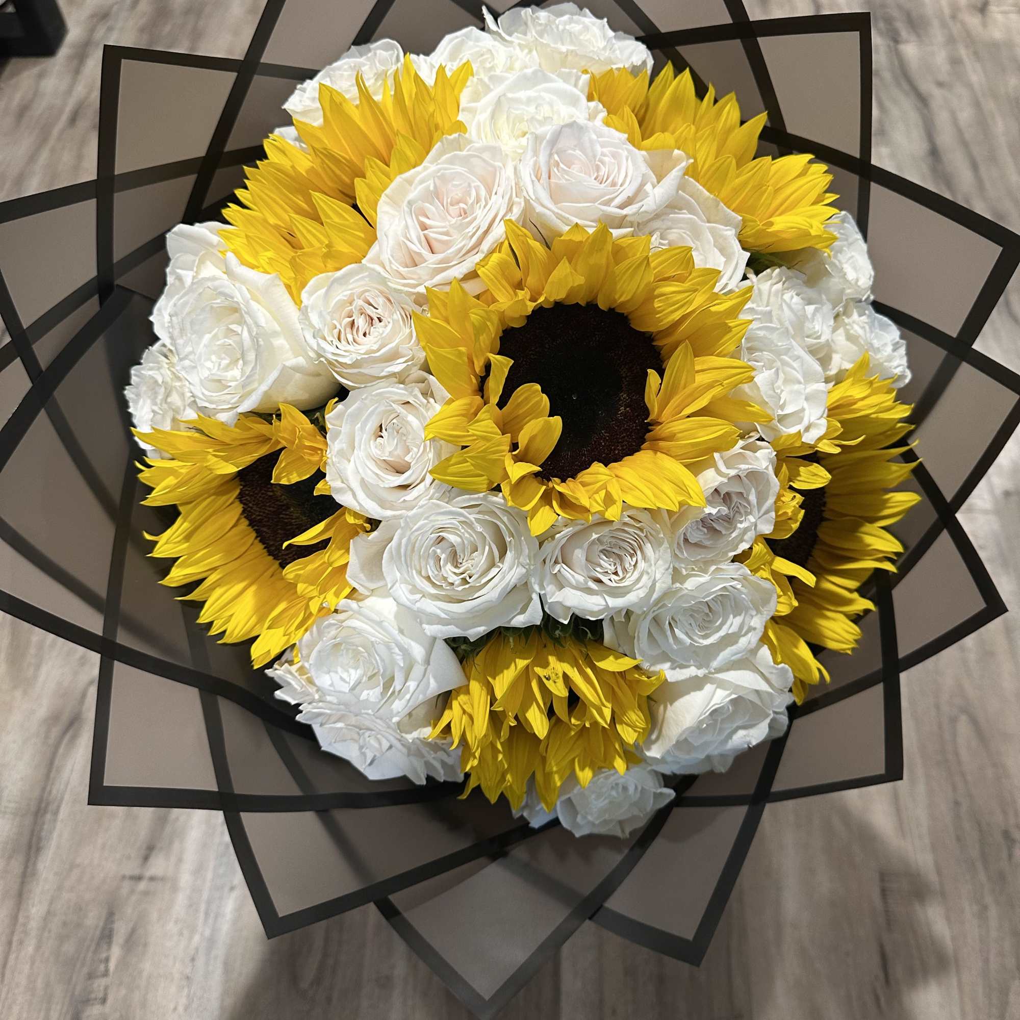 Beautiful sunflowers with white long stem roses wrapped in a luxurious Korean