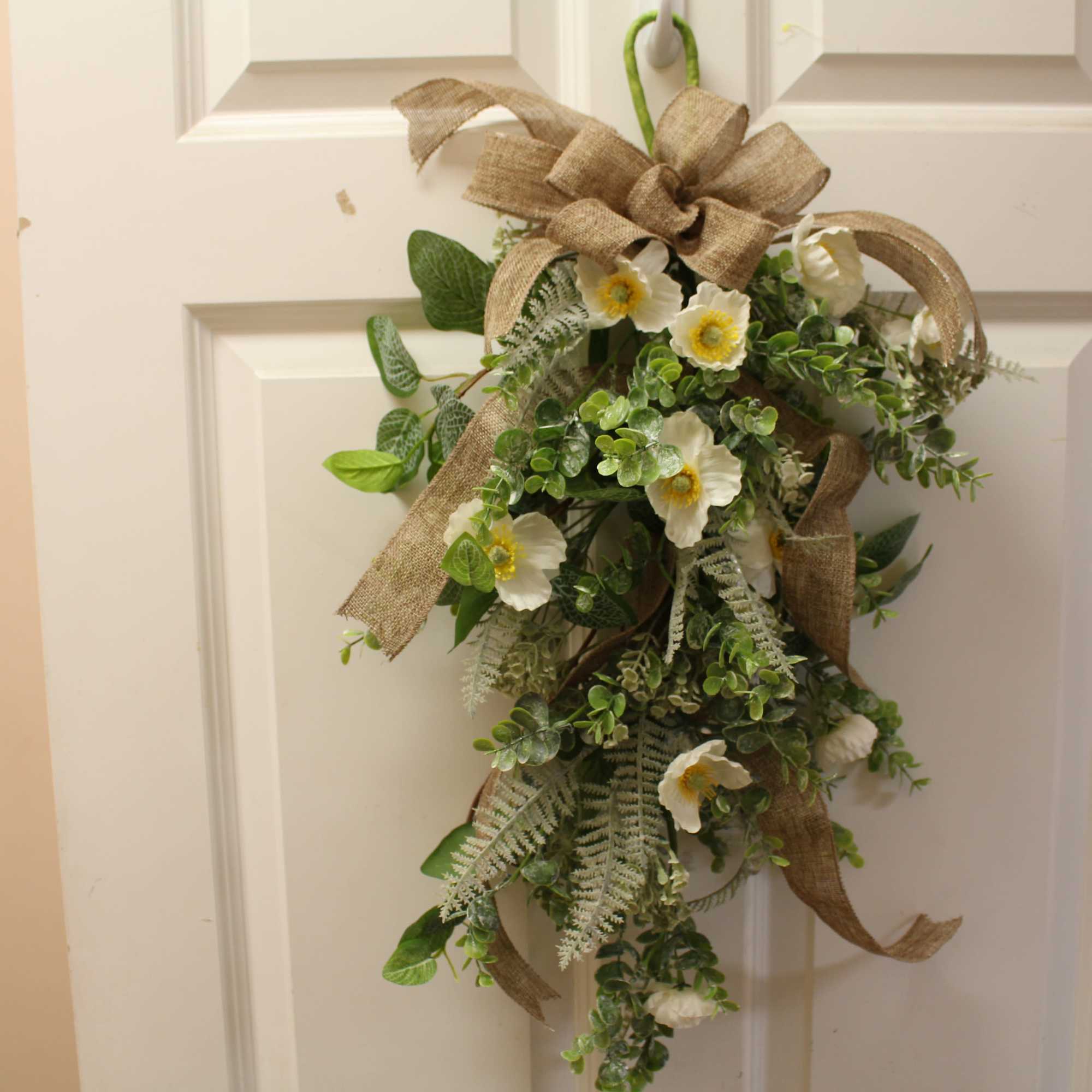 Lush with a variety of faux blooms, our Farmhouse Floral Door Swag Lush with a variety of faux blooms, our Farmhouse Floral Door Swag