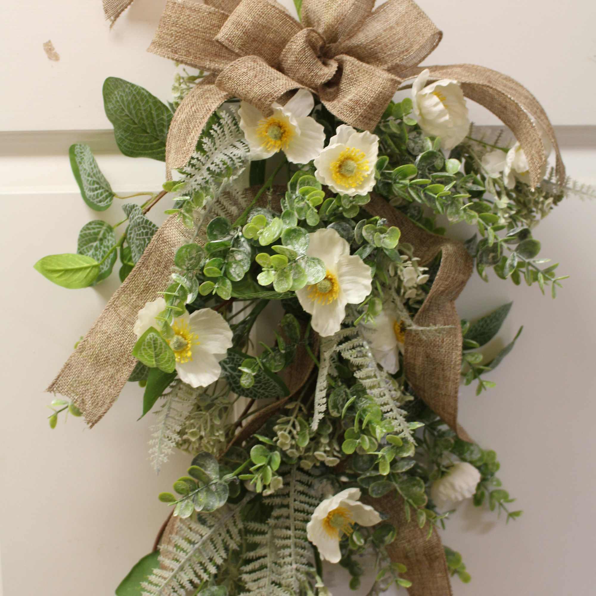 Lush with a variety of faux blooms, our Farmhouse Floral Door Swag Lush with a variety of faux blooms, our Farmhouse Floral Door Swag