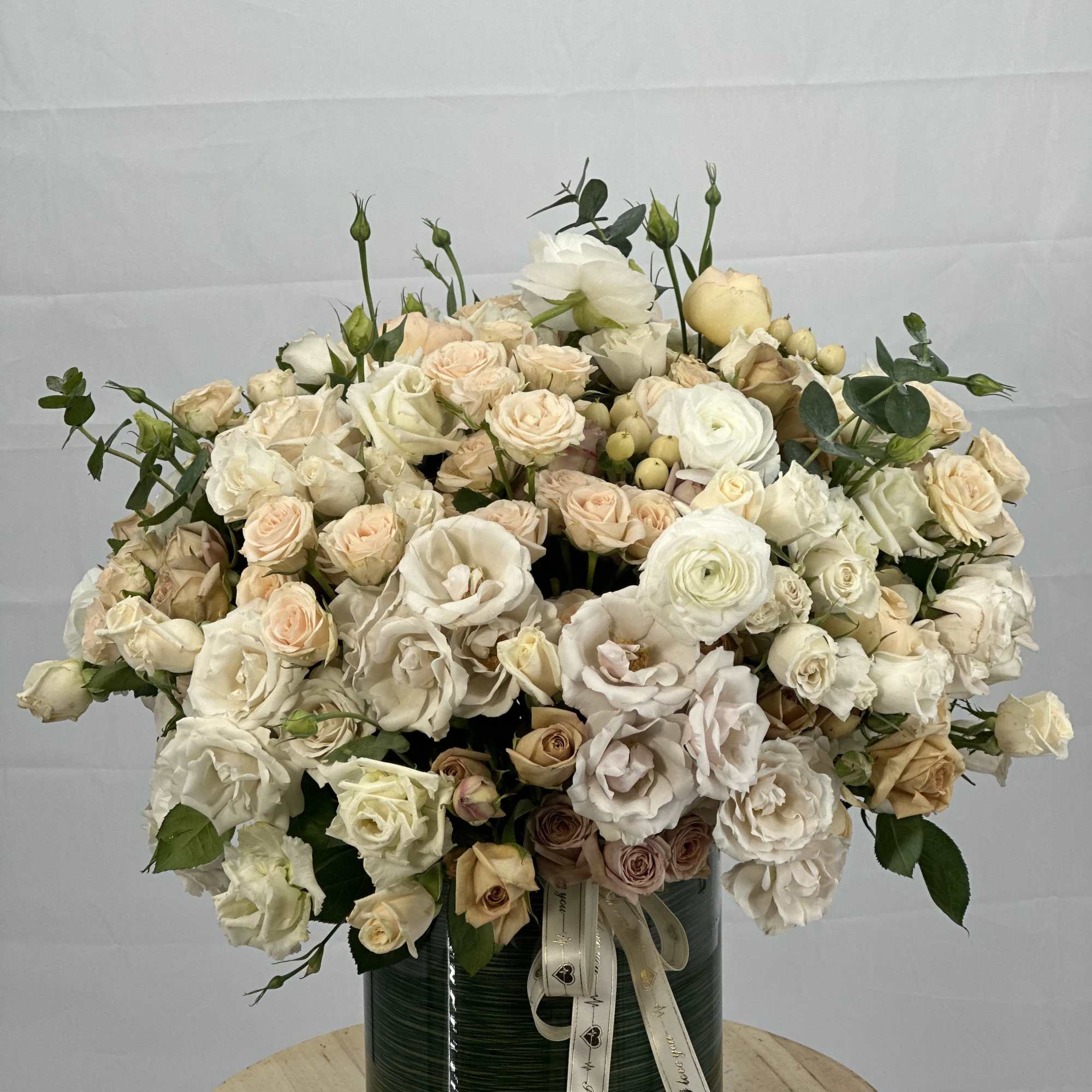 This stunning  bouquet features a captivating blend of spray roses, garden