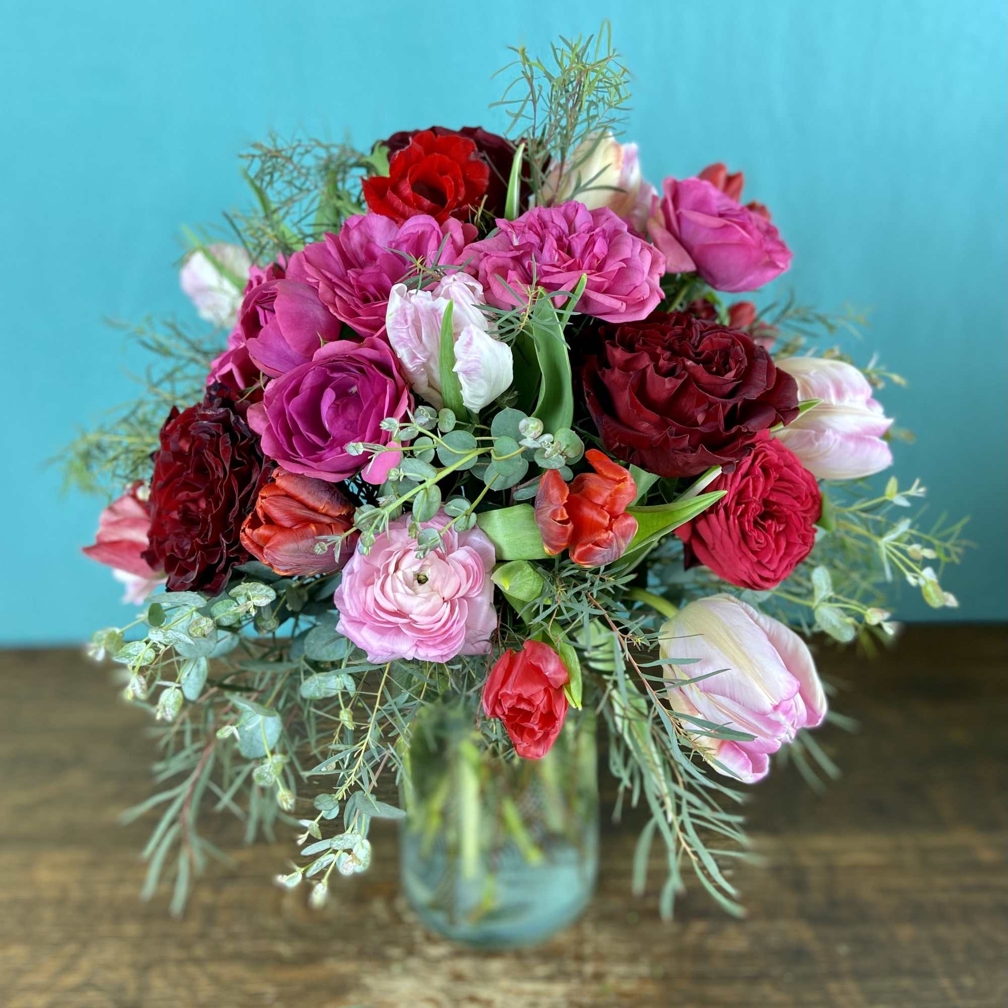 Romantic explosion of premium blooms like garden roses, double tulips, honeysuckle in