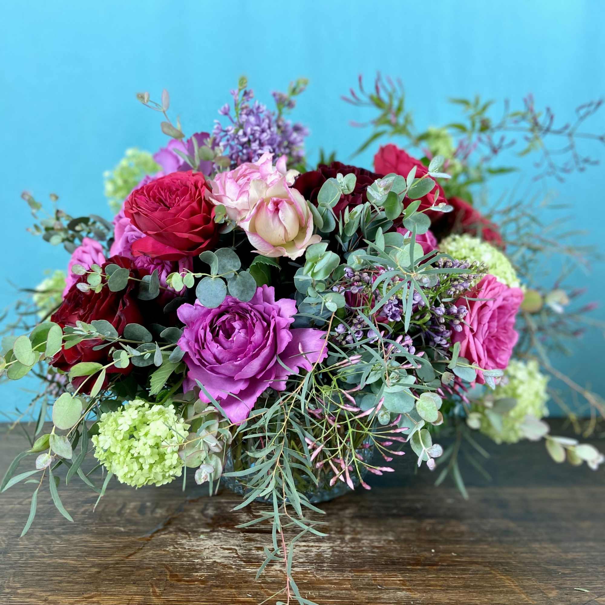 Romantic explosion of premium blooms like garden roses, double tulips, honeysuckle in
