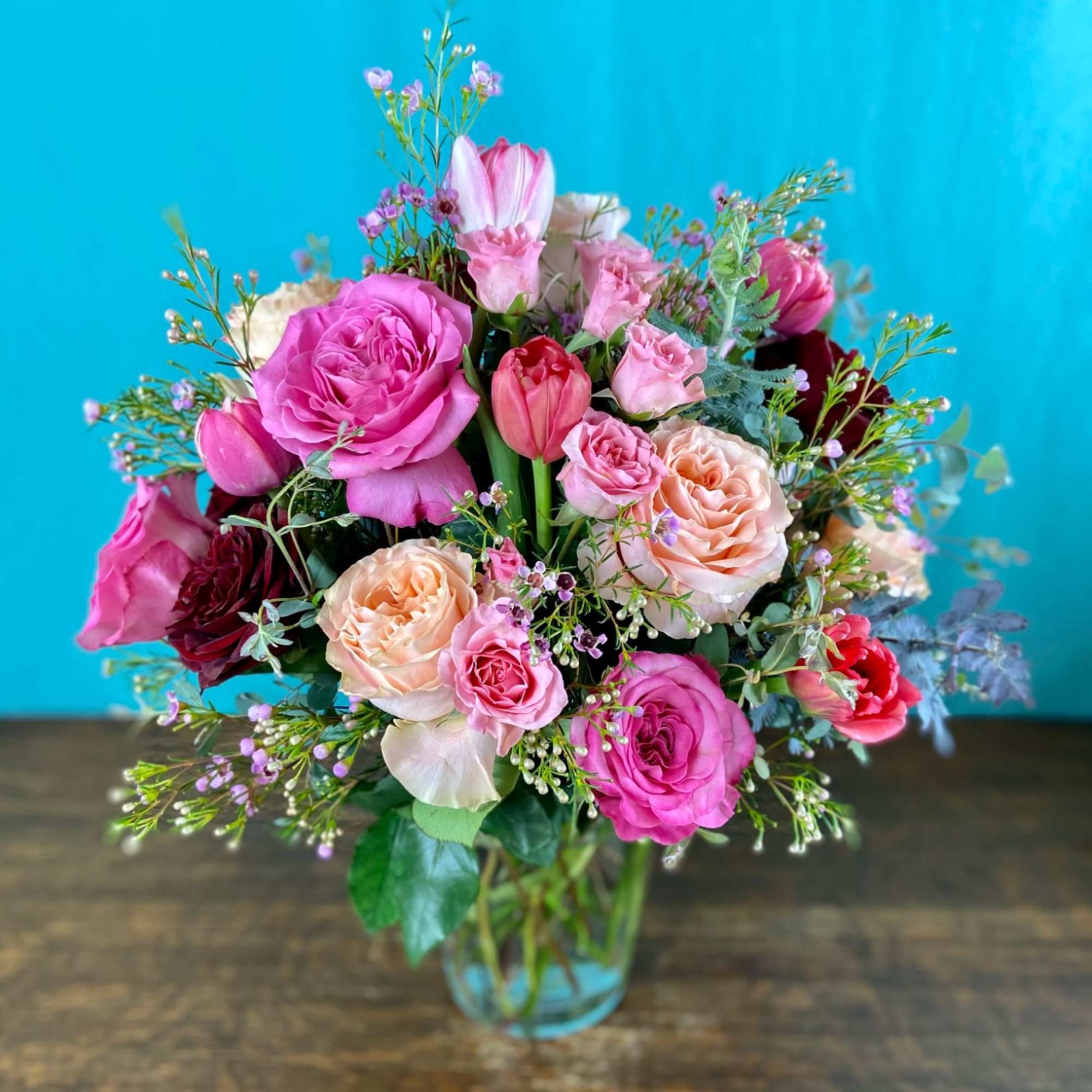 Romantic explosion of premium blooms like garden roses, double tulips, honeysuckle in