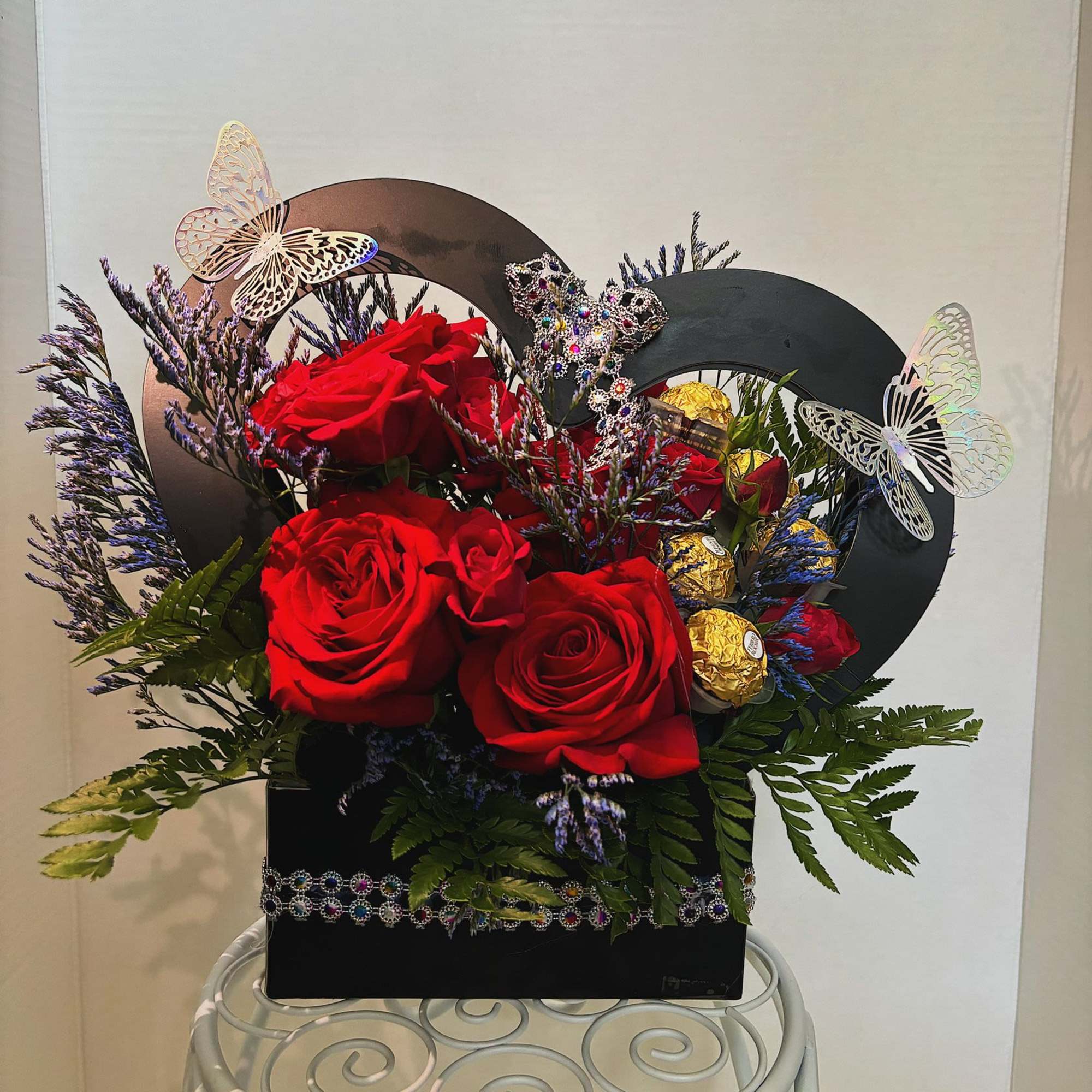 This arrangement is made with roses and chocolates. It is a small