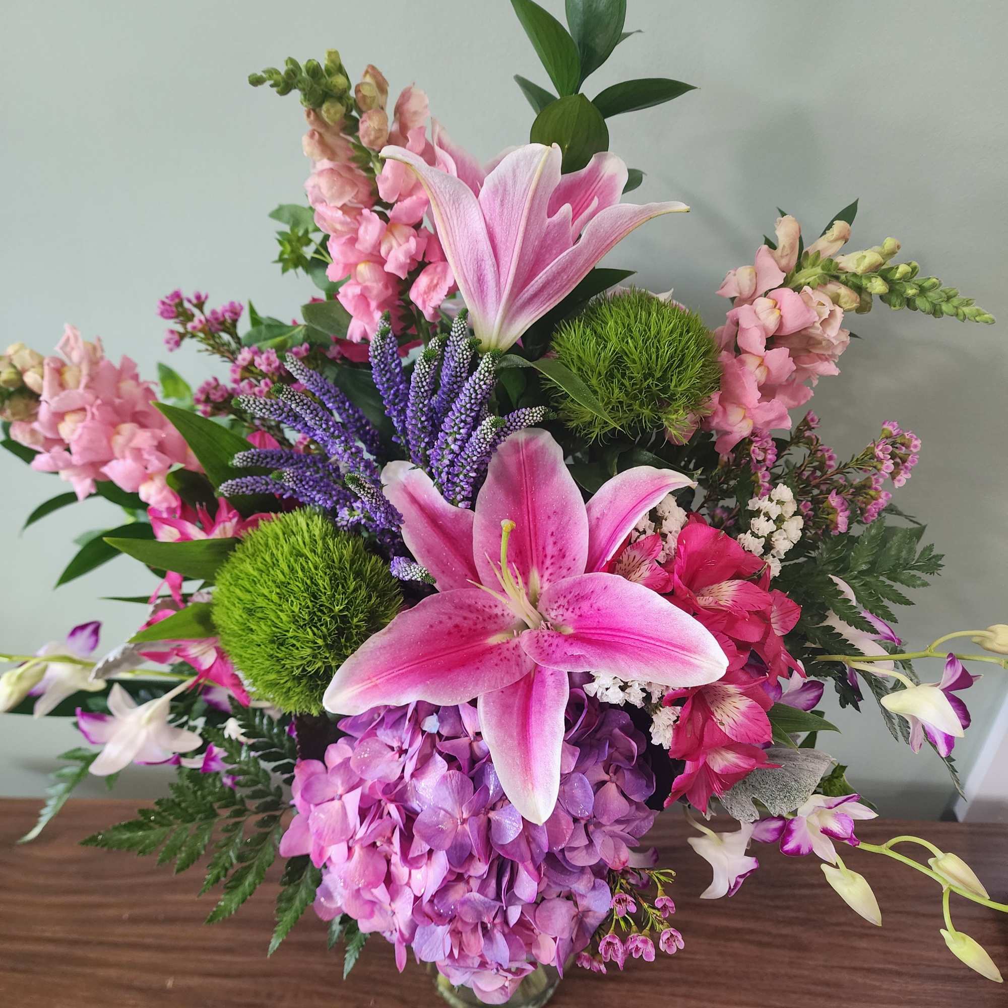 Beautiful oriental lilies, hydrangea, alstroemeria, dendrobium orchids, trick dianthus, snapdragons, accent blooms