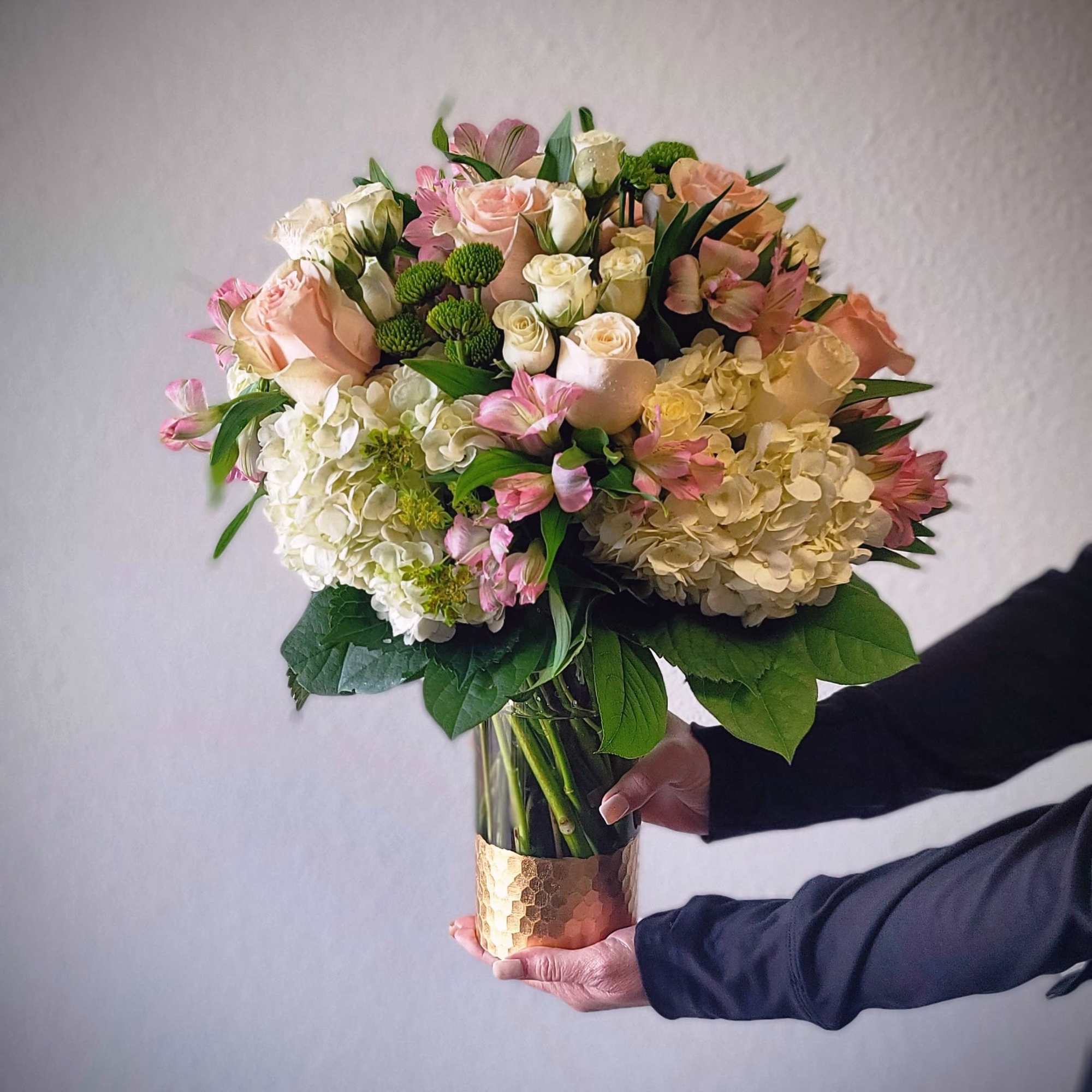 A stunning blend of blush roses, hydrangeas, spray roses, and seasonal accents