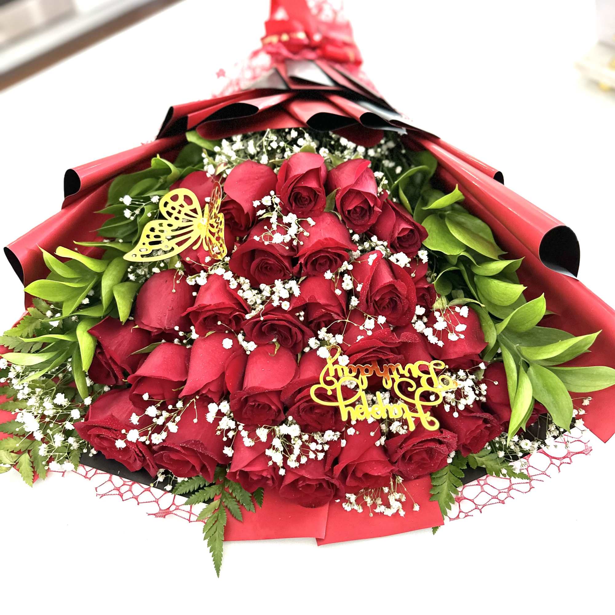 Layered red roses with greenery 