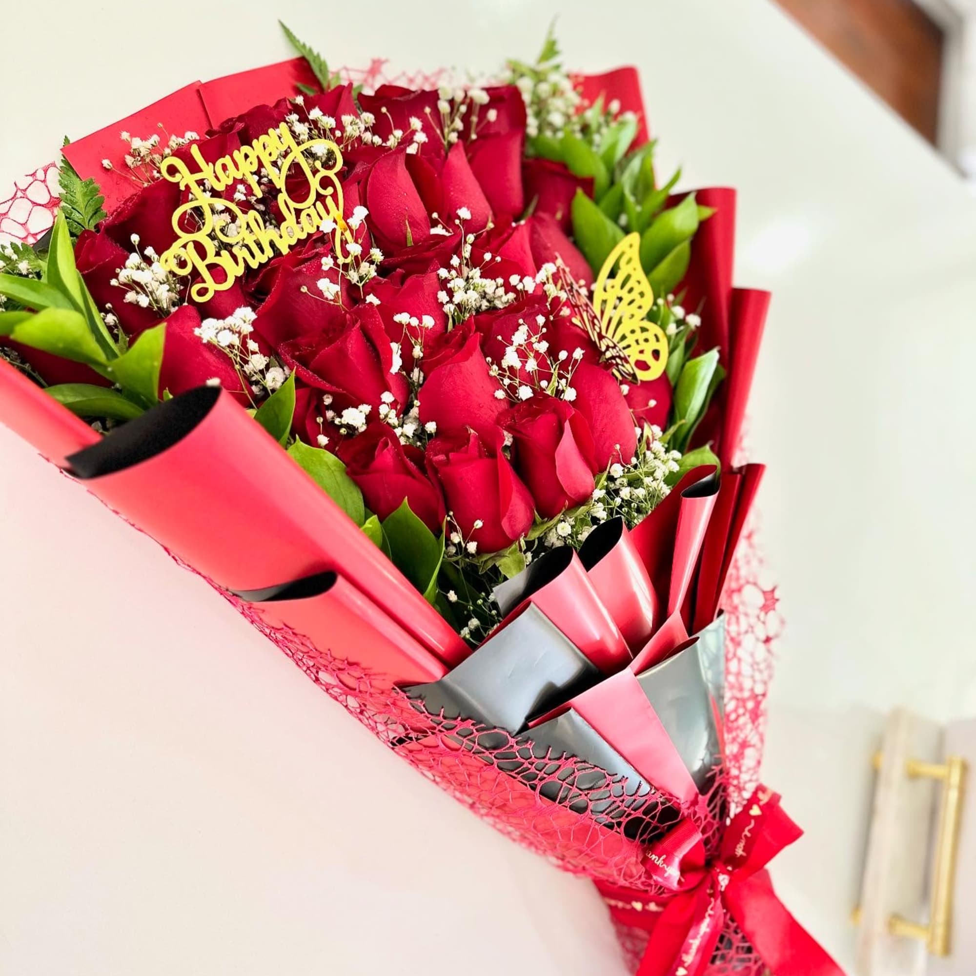 Layered red roses with greenery 