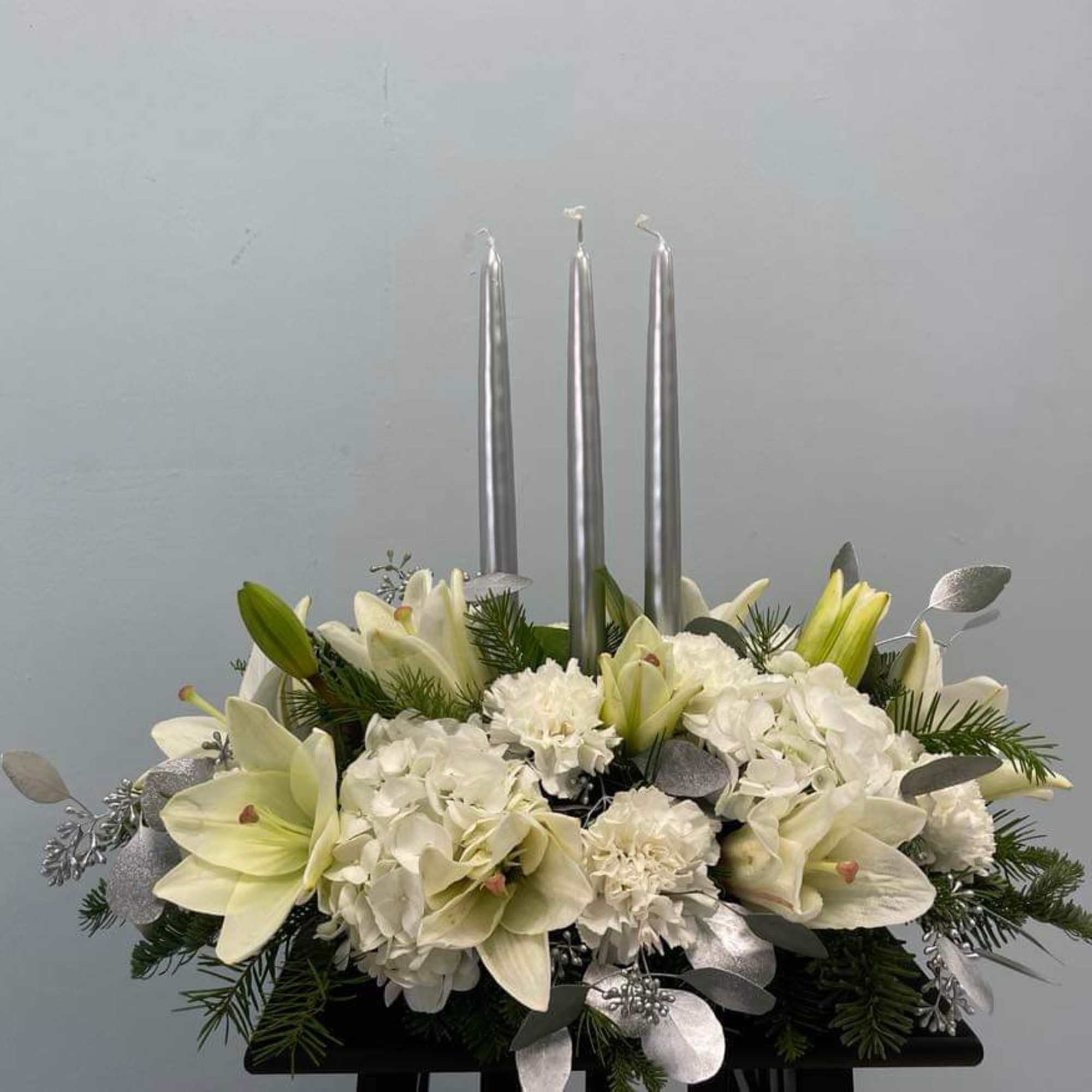 A beautiful centerpiece arrangement with a touch of silver to bring joy