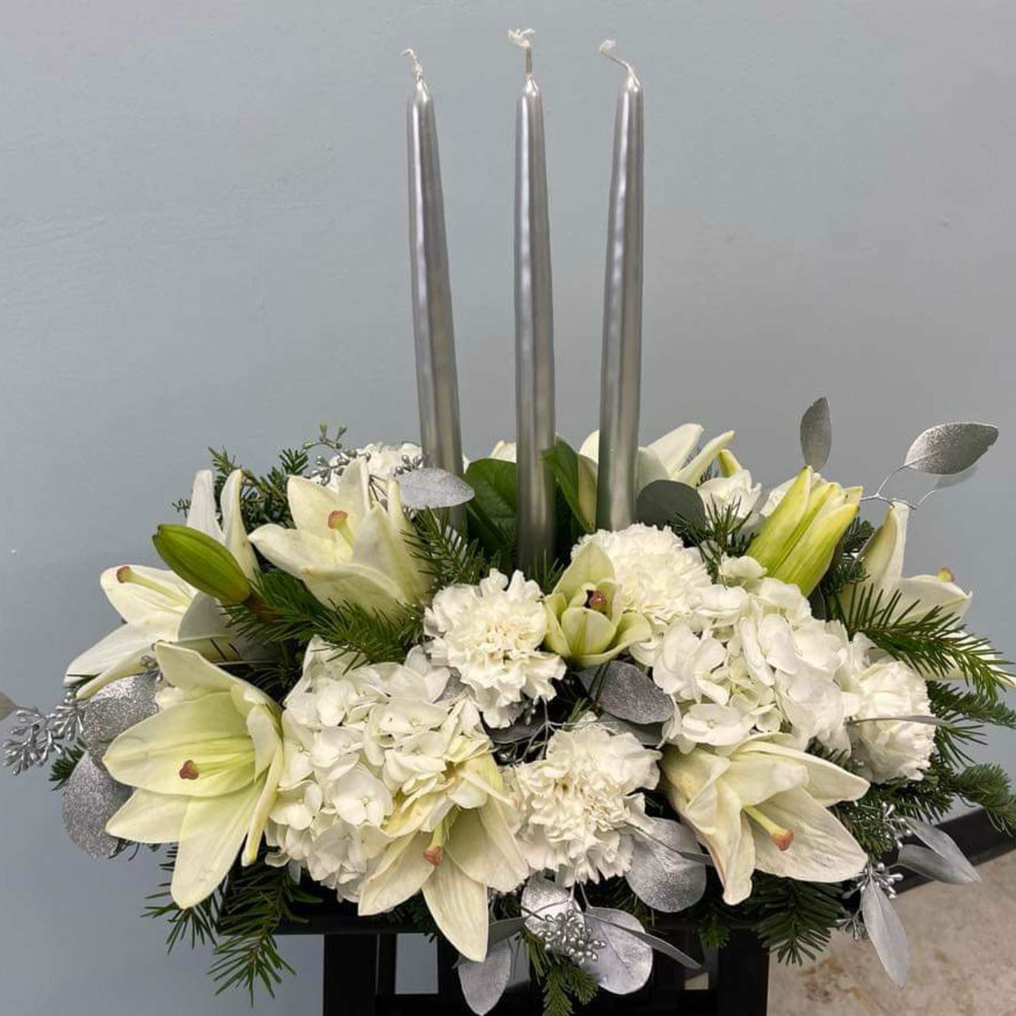A beautiful centerpiece arrangement with a touch of silver to bring joy