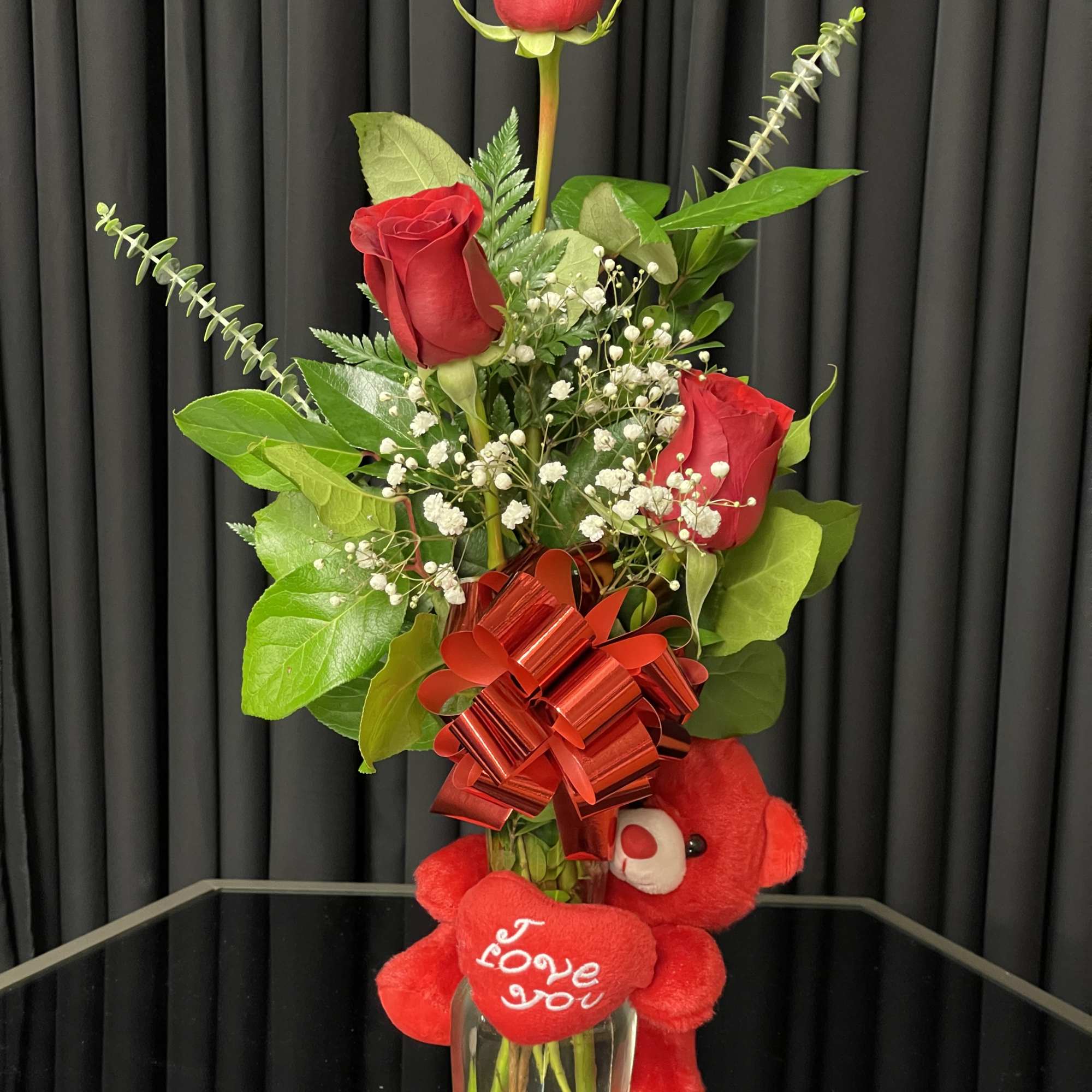 Three rose vase with lemon leaves, baby breath, and eucalyptus. Comes in