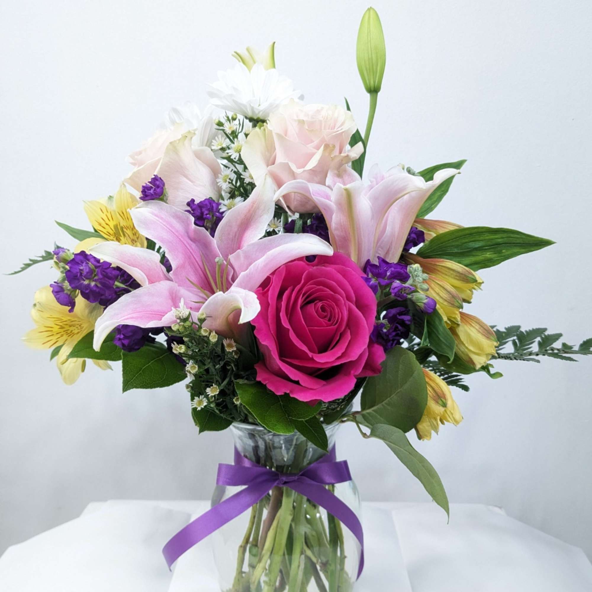 This gorgeous little bouquet includes light pink roses, pink roses, pink stocks