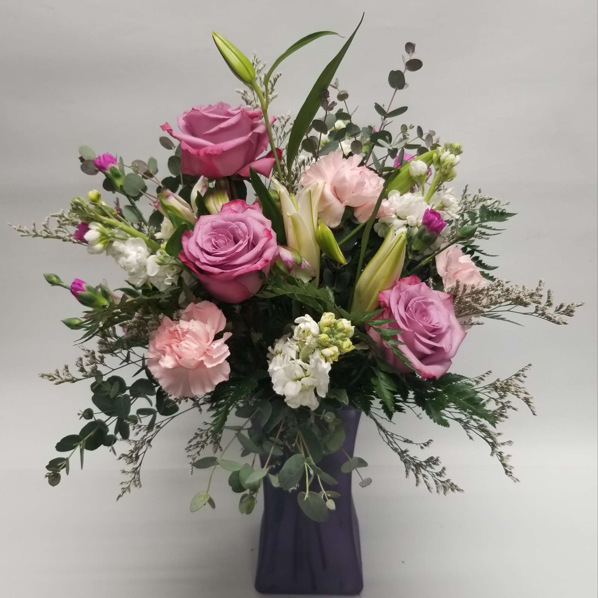 While this wonderful mix of lavender roses, stock, carnations, lilies, limonium and While this wonderful mix of lavender roses, stock, carnations, lilies, limonium and