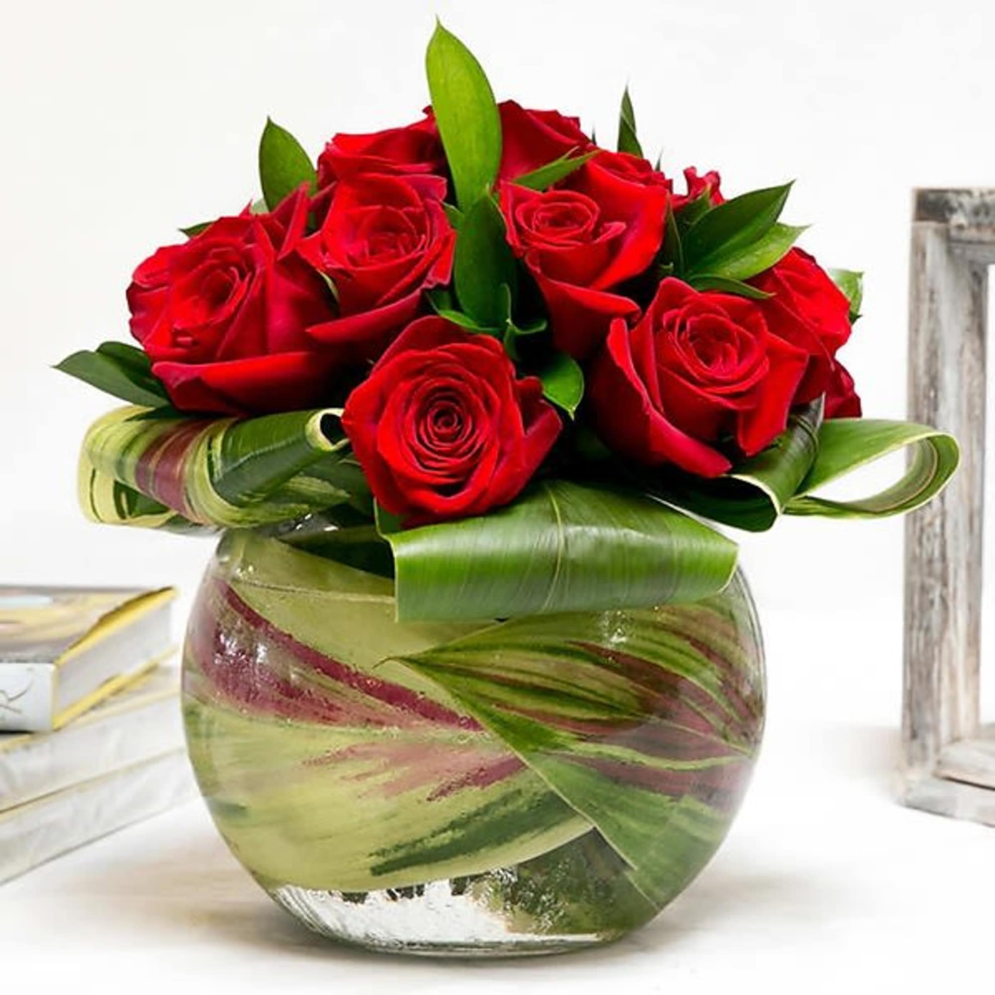 A pave of 12 red roses beautifully arranged in a bubble bowl