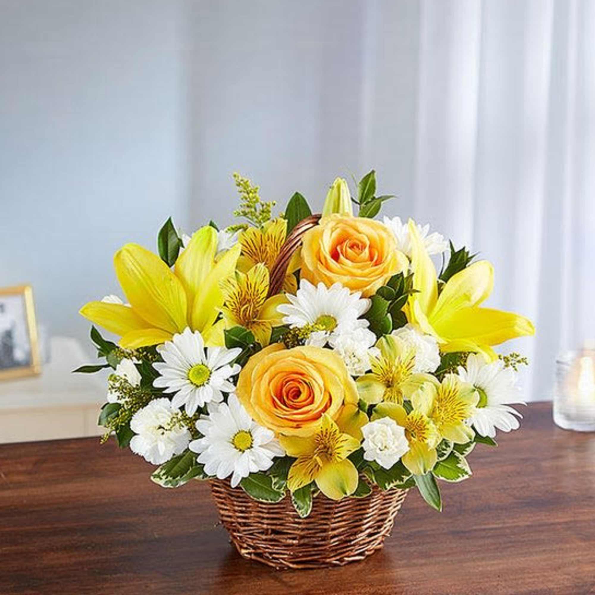Basket arrangement of yellow roses, Asiatic lilies and alstroemeria and white daisy