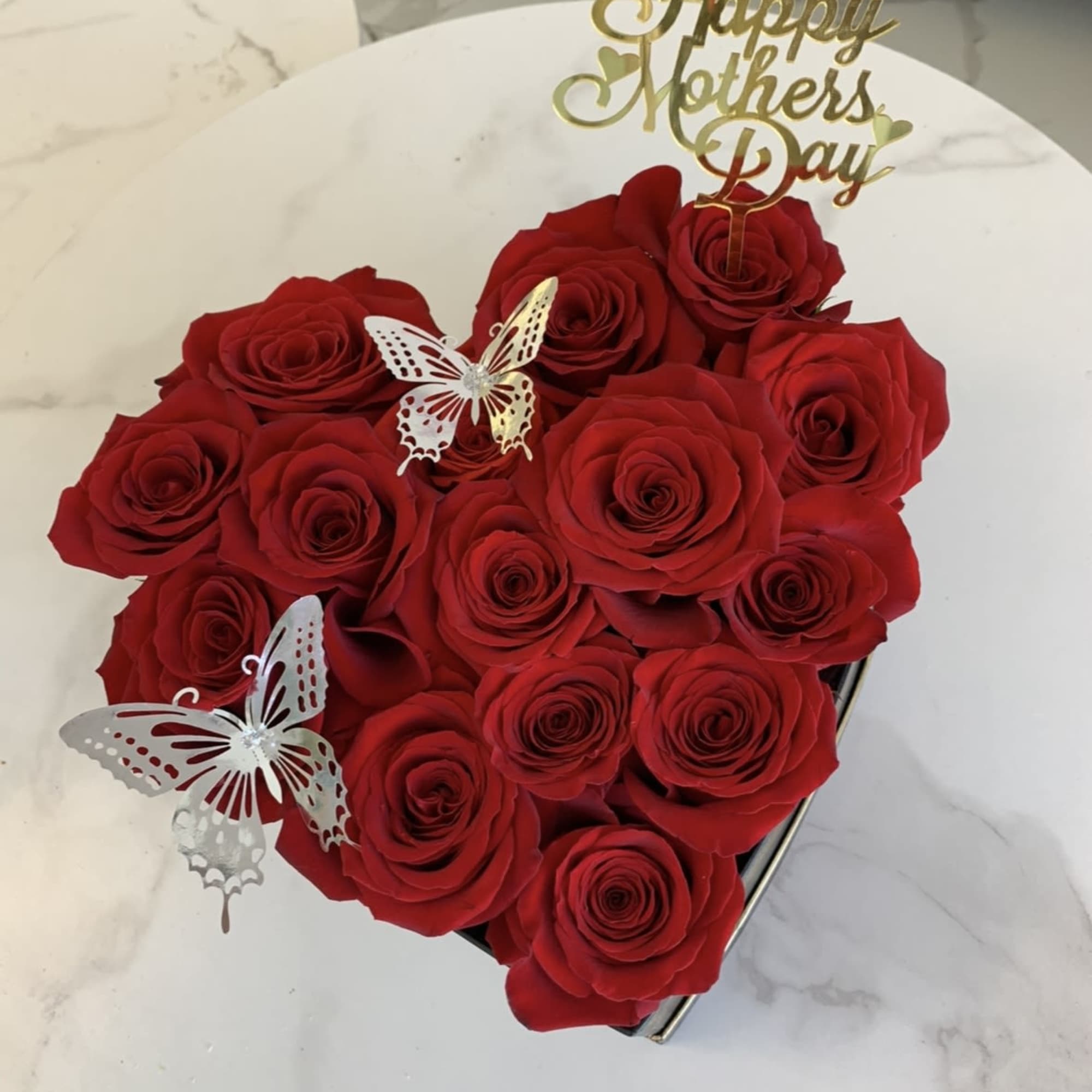Our rose heart box elegantly arranged with red roses and our golden