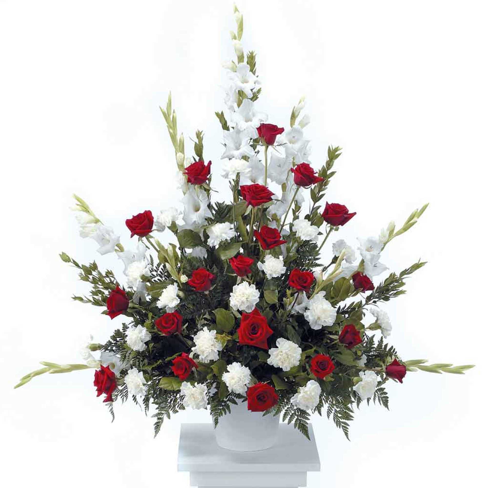 Designed with red roses, white carnations and gladiolus brought together with freshly
