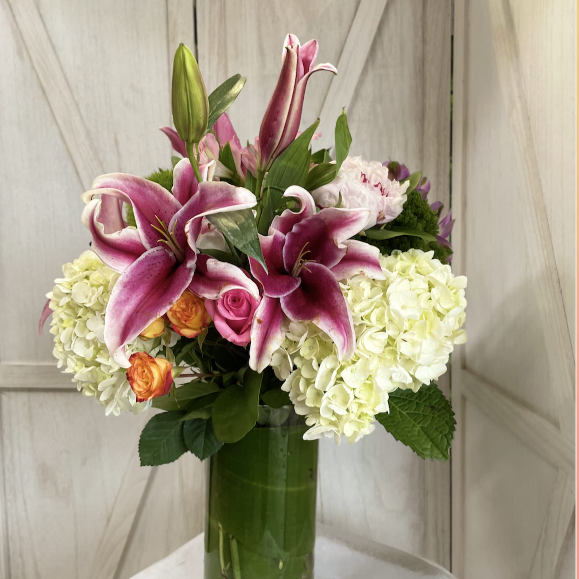 On a tropical island, fragrant roses bloom side-by-side with orchids and a