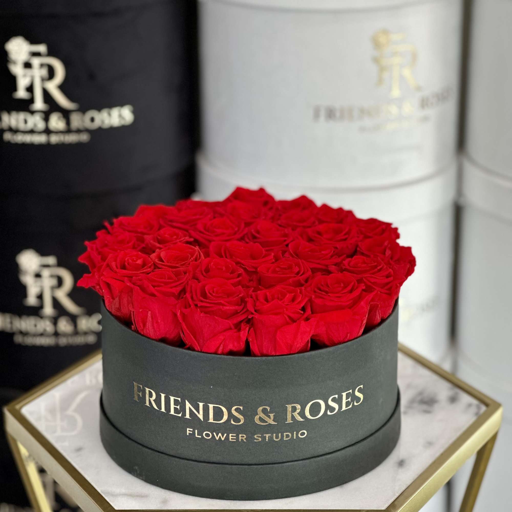 Timeless red preserved roses delicately arranged in a  black paper box&mdash;a