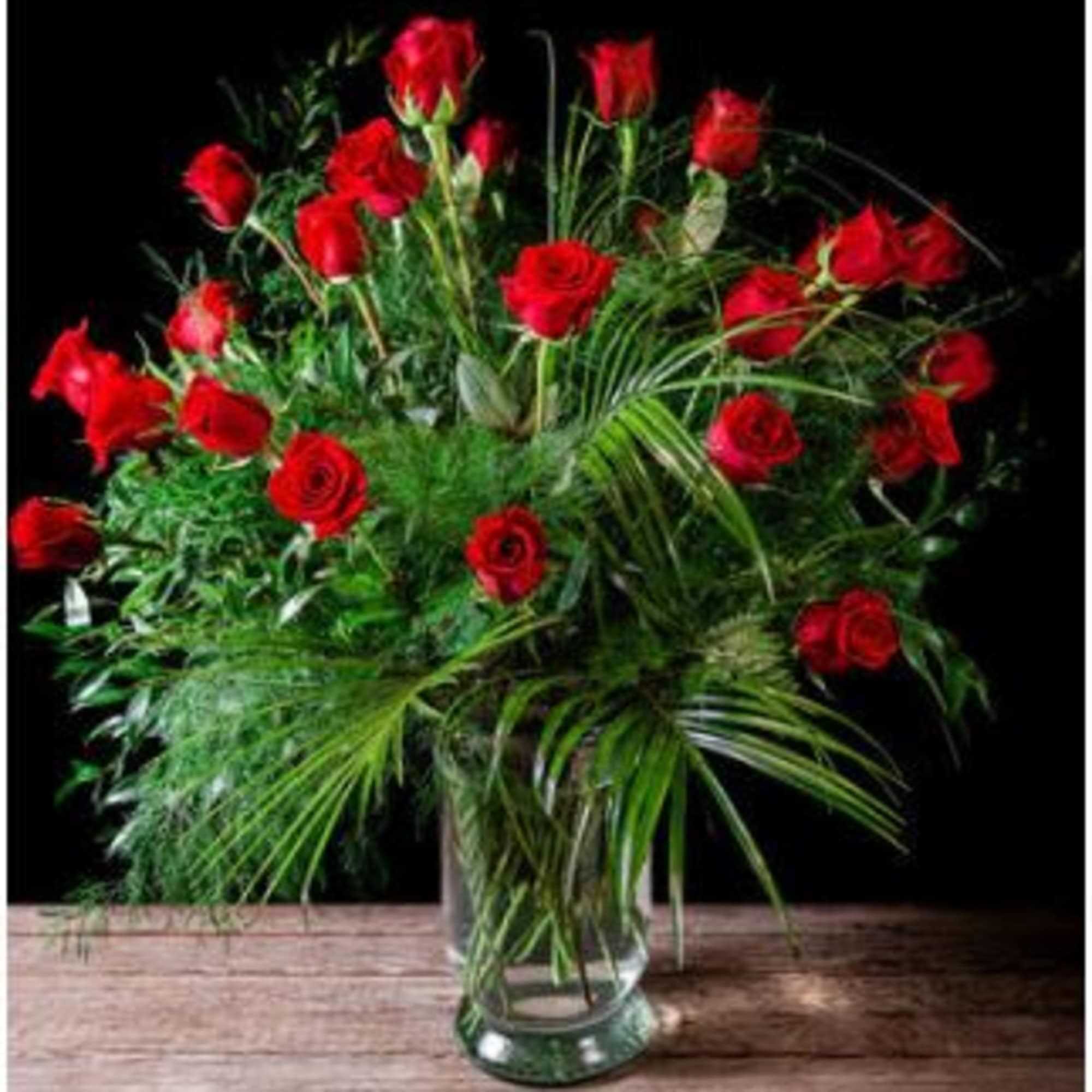 An amazing array of Long Stem Red Roses with Luxury Greens. 
