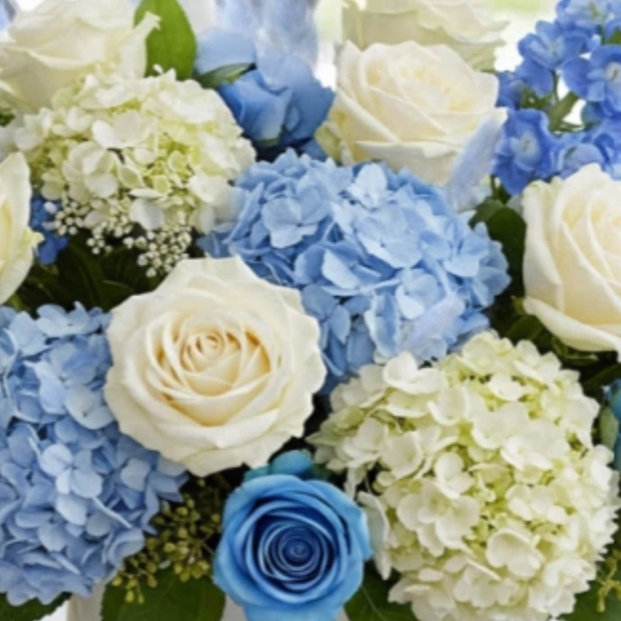 An all white tribute, this white cross funeral spray is pure and