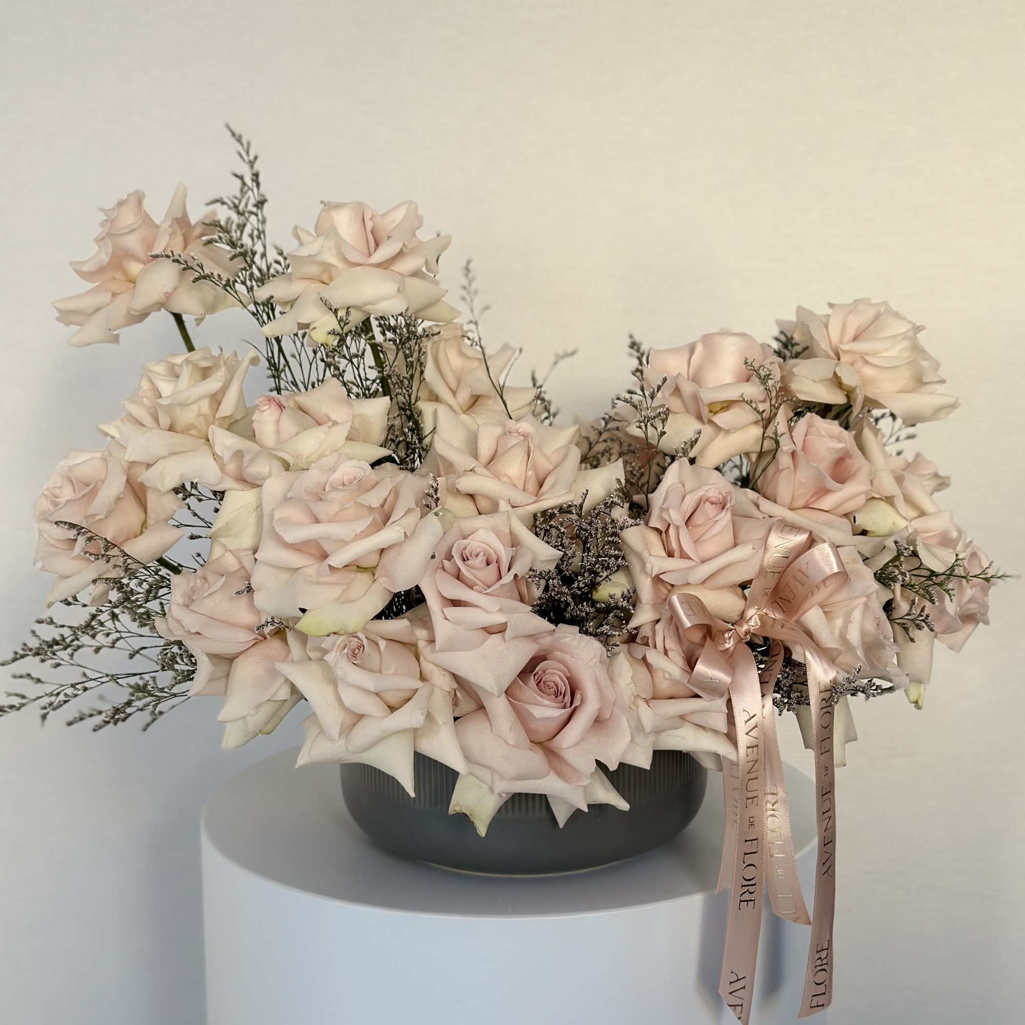 Introducing a stunning blend of delicate roses nestled in a sleek, chic